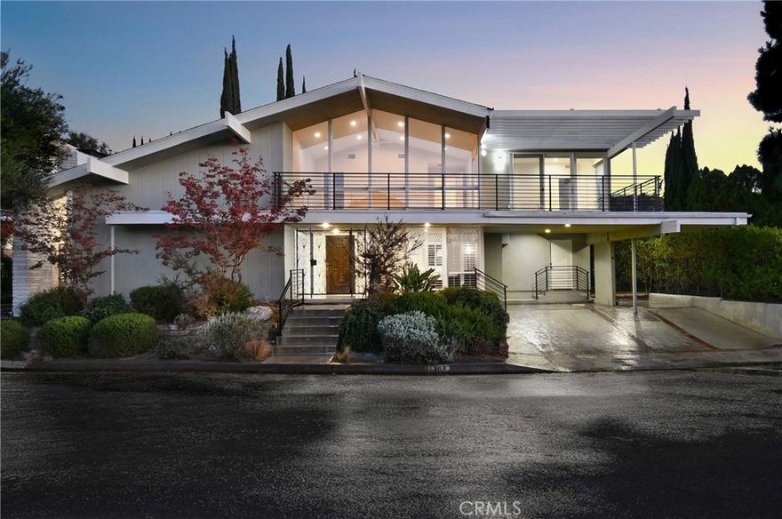 Beautiful Mid-Century Modern high in the hills of Studio City, this midcentury-inspired architectural has been remodeled with designer touches throughout. Capturing fantastic views of Studio City and the hillsides beyond, the 5-bedroom retreat features light, bright interiors, a formal dining room and a living room with soaring cathedral ceilings and a wood-burning fireplace. The remodeled chef’s kitchen boasts a center island, built-in dining nook, Quartz counters, tile backsplash, shaker cabinets, a walk-in pantry and Thermador/Miele appliances. Sliding doors open to the entertainer’s backyard with a pool, alfresco dining area, manicured gardens and terraced patios. Bedrooms and baths include the primary suite with dual closets and a double rain shower. Features include an office, leased solar and a sound system, located in the Carpenter school district, moments from the Fryman Canyon Trails and shops and restaurants on Ventura Blvd. Home needs minor repairs and a refresh.