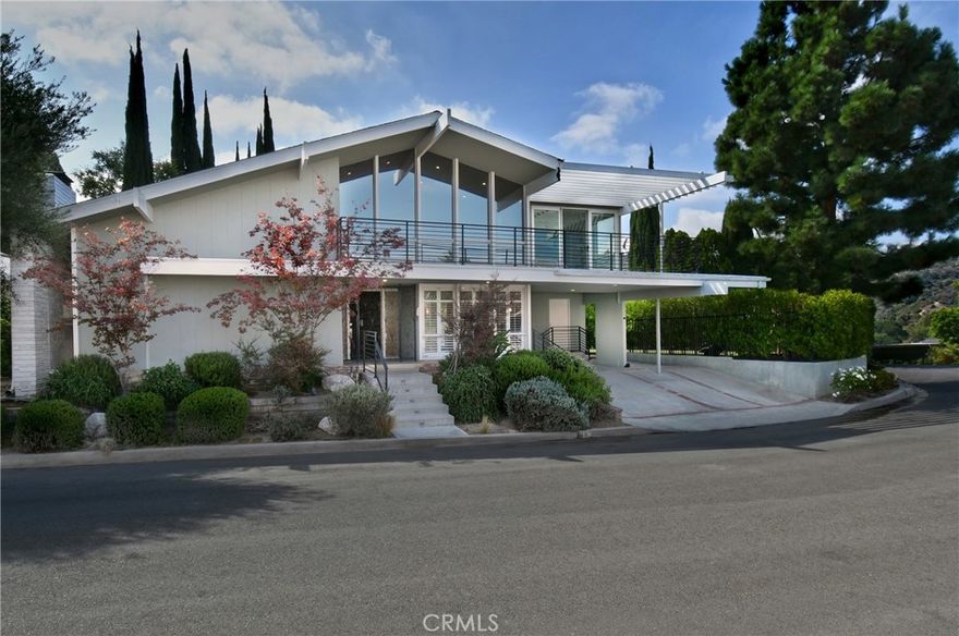 Beautiful Mid-Century Modern high in the hills of Studio City, this midcentury-inspired architectural has been remodeled with designer touches throughout. Capturing fantastic views of Studio City and the hillsides beyond, the 5-bedroom retreat features light, bright interiors, a formal dining room and a living room with soaring cathedral ceilings and a wood-burning fireplace. The remodeled chef’s kitchen boasts a center island, built-in dining nook, Quartz counters, tile backsplash, shaker cabinets, a walk-in pantry and Thermador/Miele appliances. Sliding doors open to the entertainer’s backyard with a pool, alfresco dining area, manicured gardens and terraced patios. Bedrooms and baths include the primary suite with dual closets and a double rain shower. Features include an office, leased solar and a sound system, located in the Carpenter school district, moments from the Fryman Canyon Trails and shops and restaurants on Ventura Blvd. Home needs minor repairs and a refresh.