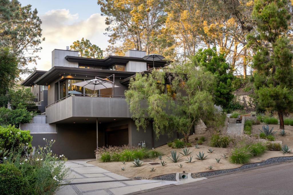 Welcome to 404 Pine Needles Drive — a stunning mid-century modern retreat with panoramic ocean views, fully remodeled in 2022 and tucked within one of Del Mar’s most exclusive and private neighborhoods. Set on a spacious 0.33-acre lot, the property offers room to build an ADU, adding even more potential to this exceptional home. Step through the lushly landscaped front yard and ascend to the main level, where natural light, warm white walls, wood accents, and curated designer lighting welcome you in. The open-concept dining and living areas seamlessly flow onto the expansive ocean-view deck through disappearing glass doors, creating an ideal setting for indoor-outdoor living and entertaining. The gourmet kitchen is a chef’s dream—featuring a large island, multiple prep zones, and top-of-the-line appliances. Just beyond, a casual dining nook opens into a versatile recreation space, currently set up as a pool table and bar area. A disappearing partition allows you to close off the space for added privacy. Off the kitchen, a second outdoor lounge with a fire pit and built-in barbecue offers a serene, ultra-private escape, while another side patio leads to a convenient storage room. A stylish powder room completes the main level. The primary suite is a true sanctuary, complete with custom drapery and motorized blinds, sweeping ocean views, a spacious rooftop deck, spa-like bathroom with soaking tub and walk-in shower, and an expansive custom walk-in closet. Two guest bedrooms share a Jack and Jill bath, each with its own sink and toilet for added privacy. See supplement... Two guest bedrooms share a Jack and Jill bath, each with its own sink and toilet for added privacy. One of the bedrooms includes a bonus space, perfect as an office or nursery. Both bedrooms open to a large outdoor terrace—ideal for children or pets to enjoy safely. The lower level includes an additional guest bedroom, full bath, and a bonus room currently used as a wine cellar and home gym. A large laundry room with built-in storage and the home’s elevator round out the level. The oversized two-car garage and private driveway offer generous parking and storage. This is more than a home—it’s a work of art. Located just minutes from iconic Del Mar beaches, Torrey Pines State Reserve, Del Mar Village, the Del Mar Racetrack, and top-rated schools, with easy access to I-5 and nearby shopping.