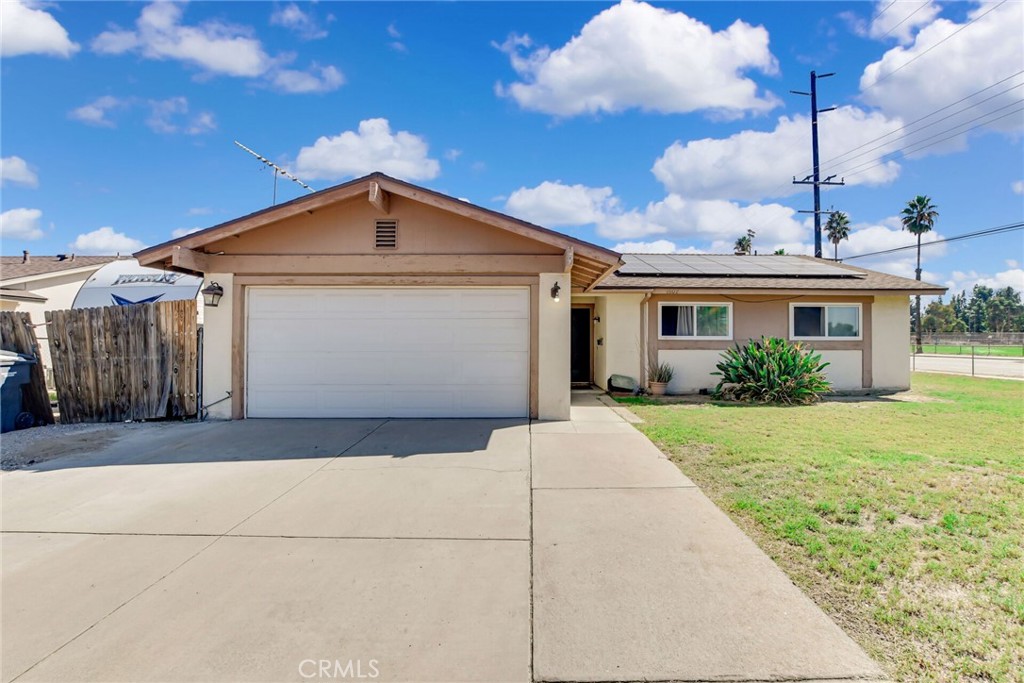 This is a large corner lot with a four bedroom two bath solar home. It is enclosed with a chain-link fence and a gate, Behind the wooden fence is RV parking, so you have a place for your toys. Inside is the large living/family room with connection to the bright eat-in kitchen, which is the heart of the home. These rooms are tiled for allergy sensitive noses and the bedrooms all have carpet. This has potential, it just needs your imagination and personal touches. There is a covered patio just perfect for your family and friends to gather for a BBQ or a game of croquet in the large backyard. Come see for yourself and make this your forever home.