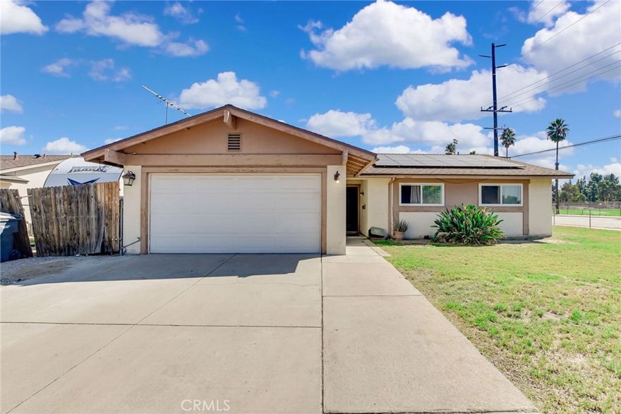 This is a large corner lot with a four bedroom two bath solar home. It is enclosed with a chain-link fence and a gate, Behind the wooden fence is RV parking, so you have a place for your toys. Inside is the large living/family room with connection to the bright eat-in kitchen, which is the heart of the home. These rooms are tiled for allergy sensitive noses and the bedrooms all have carpet. This has potential, it just needs your imagination and personal touches. There is a covered patio just perfect for your family and friends to gather for a BBQ or a game of croquet in the large backyard. Come see for yourself and make this your forever home.