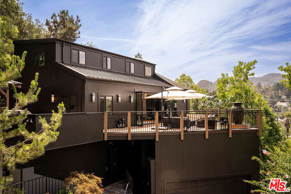 Modern Mountain Retreat overlooking prime Chevy Chase Canyon. Experience bespoke serene luxury - the main floor w/ walnut hardwood floors, large living room w/ custom media experience, 12 foot Onyx fireplace, dining + separate study and large chef's kitchen w/ Italian Polyform cabinetry and Miele appliances. Primary suite as true sanctuary - complete with closet, dressing room, loft space and perfect bathroom w/ Ann Sacks tile and Toto appliances. 3bd/ 2ba upstairs for family and guests. Lower floor features dressing room/gym, large closets and bathroom, a large climate controlled wine cellar, laundry/storage and in-law suite w. private entrance. Outside feels more akin to a Lake Tahoe Chalet, with large swimming pool, in ground and above ground spas, koi pond and fountains, and thoughtfully designed seating areas, outdoor fireplace + kitchen and gaming area, all surrounded by mature trees and inspiring canyon views. An unfindable combination of home and getaway.