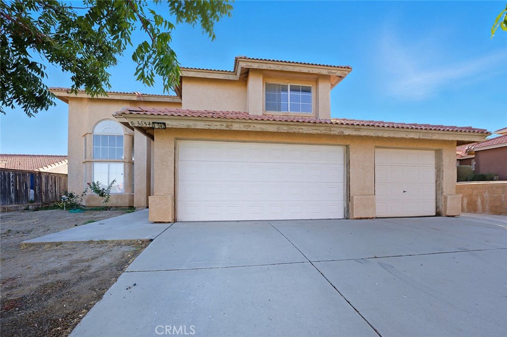 Needs some updating but priced to reflect that! Very OPEN floorplan with vaulted ceilings and one bedroom and bath downstairs perfect for guests or office. Three nice sized bedrooms upstairs and full bath in the hallway. Huge primary bedroom with large bathroom and walk-in closet. Large kitchen facing backyard. Primary bedroom is huge with large full bath as well. Utility room next to spacious 3-car finished garage. Note storage area under stairs! It is huge and can be great as a huge walk-in closet or perhaps even a nice wine cellar. Easy maintenance backyard with covered patio and more. The possibilities are endless for your new home!