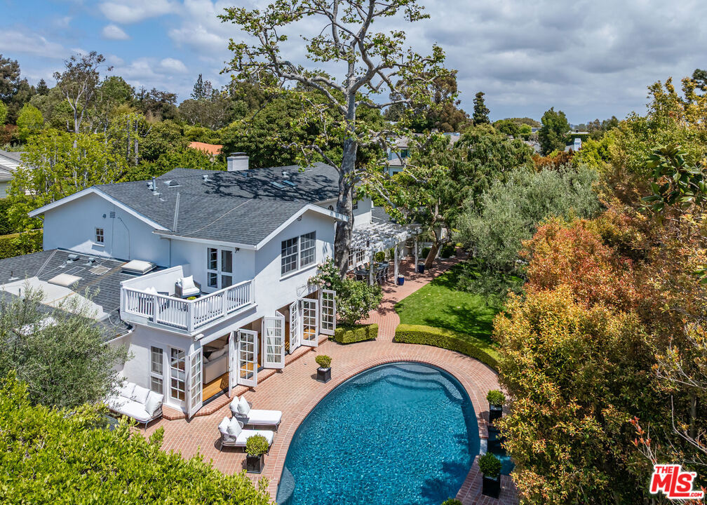 Welcome to 13600 Romany Drive, a stunning traditional estate nestled in the heart of the prestigious Palisades Riviera. This beautifully appointed 6-bedroom, 6-bathroom home offers approximately 5,800 square feet of refined family living space on a lush, gated lot designed for ultimate privacy and tranquility. Step through the grand entry into a gracious, sunken living room perfect for entertaining or relaxing by the fireplace. The formal dining room sets the stage for elegant gatherings, while the spacious chef's kitchen opens to a light-filled great room ideal for casual living and family time. Additional features include a dedicated home office, fully equipped gym, and separate maid or guest quarters. Upstairs, you'll find three oversized children's bedrooms along with a luxurious primary suite complete with a private balcony, spa-like bath, large Jacuzzi tub, and serene views of the manicured grounds. Outdoors, enjoy your own private oasis with a sports court, resort-style pool with waterslide, zip line, golf putt, and swingset creating an unmatched experience for both kids and adults alike. The beautifully landscaped grounds also feature a charming herb garden, perfect for home cooking and al fresco dining. Mature landscaping, endless lawn, and tall hedges provide the seclusion and beauty expected in this iconic neighborhood. This timeless estate seamlessly combines classic charm, modern comforts, and unforgettable outdoor amenitiesall in one of Los Angeles' most coveted locations.