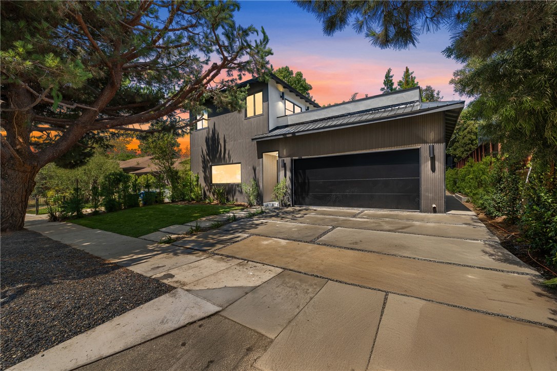 Hidden on a quiet tree-lined street in Mar Vista Hill, this home has been fully ground-up renovated with exceptional attention to detail, almost like a new construction. Crafted with high-quality finishes, it features quartz countertops, white oak wood cabinetry, and modern design elements throughout. The spacious layout includes a living room that opens seamlessly to the formal dining area, and a modern open-concept kitchen with a breakfast nook that overlooks the large family room with sliding doors to the backyard. The home offers four spacious bedrooms and a versatile den with a cozy fireplace, ideal for relaxing or entertaining. Step outside to a perfect private green backyard, ideal for outdoor living and gatherings. The main level also hosts two bathrooms. Upstairs, you'll find a luxurious primary suite—private and tranquil, equipped with a full bathroom and a rooftop deck. The location offers a true suburban feel while providing convenient access to Santa Monica and the rest of LA.