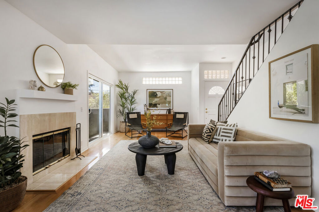Welcome to this bright and inviting front-facing 2 bed, 2.5 bath townhouse, located in a small community in the heart of Valley Village. The main level features oak hardwood floors, a cozy fireplace, and walls of windows that flood the space with natural light. A newly remodeled kitchen shines with brand-new stainless steel LG appliances, generous counter space, and plenty of storage, while a convenient powder room completes the first floor. Head upstairs to find two spacious bedrooms, each with their own ensuite bathroom, soaring ceilings, and huge closets. Additional highlights include a private, direct-access 2-car garage with an EV charger, brand-new washer and dryer, new HVAC system, and even a dedicated walk-in storage closet. Zoned for an excellent elementary school, this home is just minutes from Gelson's, Starbucks, Harvest Moon Kitchen, the Chandler bike/jogging path, the Studio City Farmer's Market, the NoHo Arts District, and the 101 and 170 freeways. With style, space, and an unbeatable location, this townhouse truly has it all!