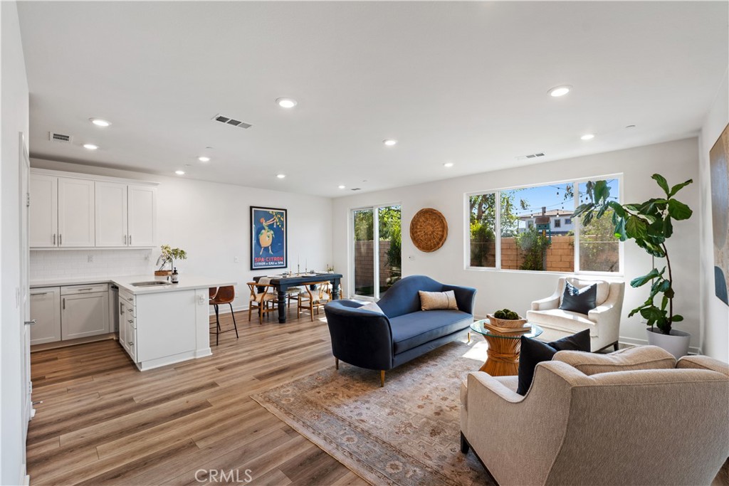 Tucked inside a quiet, gated community of just eight homes, this 4-bedroom, 3-bathroom home offers space, comfort, and a thoughtful layout in a prime Northridge location. Built in 2021, it blends the convenience of urban living in a suburban setting, just minutes from local shops, restaurants, and top-rated schools. The main floor features an open-concept living and dining area with luxury vinyl plank flooring and a bright, functional kitchen complete with quartz countertops and a stainless steel appliance package. Upstairs, you'll find all four bedrooms, including a spacious primary suite with a walk-in closet and room to relax. A second-floor laundry room adds everyday convenience, and the additional bedrooms are generously sized for family, guests, or a home office. The private backyard is a standout feature, offering a great space for outdoor dining, play, or simply enjoying the sunshine. Low HOA dues help maintain the security and charm of this small gated community while keeping monthly costs manageable.