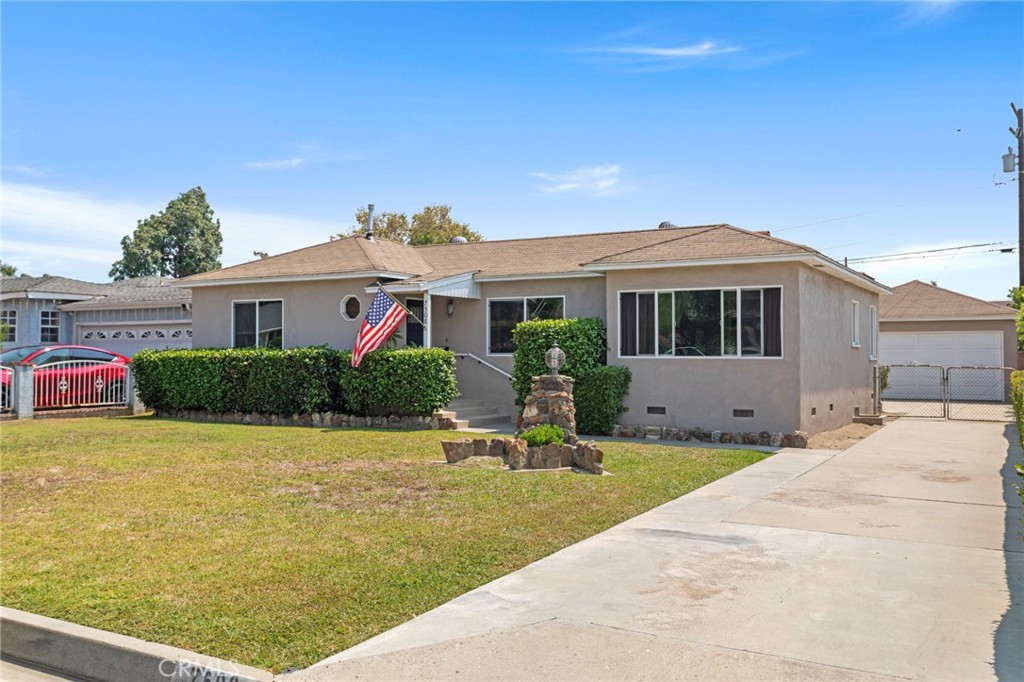 Incredible opportunity on a spacious 7,419 sq ft lot in a desirable Downey neighborhood! This well-maintained 2-bedroom, 1-bath home offers approx. 1,302 sq ft of living space with a classic, functional layout. Step inside to find a light-filled living room with large windows, a cozy brick fireplace, original hardwood floors, and a dedicated dining area. The kitchen includes ample cabinet space and a breakfast nook with backyard views. Both bedrooms are generously sized and share a full bath with vintage charm. The oversized backyard offers endless potential—perfect for outdoor entertaining, gardening, or building an ADU. Detached 2-car garage and long driveway provide plenty of parking. Located on a quiet, tree-lined street close to schools, parks, dining, and freeway access. A rare chance to customize or expand on one of the larger lots in the area!