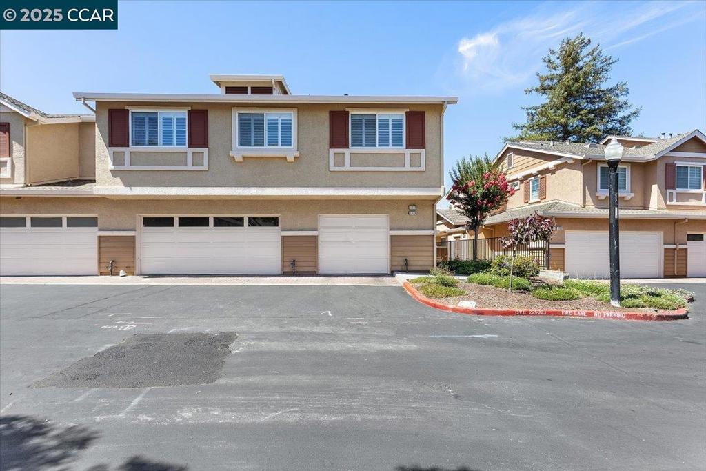 OPEN SAT/SUN! Beautifully remodeled end-unit condo (no neighbors above or below!), offering style & function in a prime San Ramon location. Upgraded just over a year ago, this bright & spacious 2-bedroom home is filled w/natural light, modern finishes, & inviting spaces. Step inside to discover vaulted ceilings & beautiful wide plank engineered hardwood flooring. The open-concept design flows effortlessly into a spacious kitchen featuring a center island, quartz countertops, porcelain tile backsplash, soft-close cabinetry, & high-end stainless Samsung & Frigidaire appliances. Working from home? You’ll appreciate the built-in desk, seamlessly integrated into the kitchen space—perfect for productivity w/out sacrificing design. The 2 bedrooms are serene w/ceiling fans & plantation shutters, one w/a generous walk-in closet. The fully remodeled bathroom feat: a sleek marble vanity & gorgeous walk-in shower. Add.'l highlights: new light fixtures & door/cabinet hardware, & dedicated garage equipped w/ Tesla charger hookup, laundry & storage space. Entry-level closet adds even more convenience. Enjoy the guest parking, community tot lot & access to top-rated San Ramon schools, parks & trails, City Center Bishop Ranch, The LOT, easy freeway access for commuters & more! THIS IS IT!