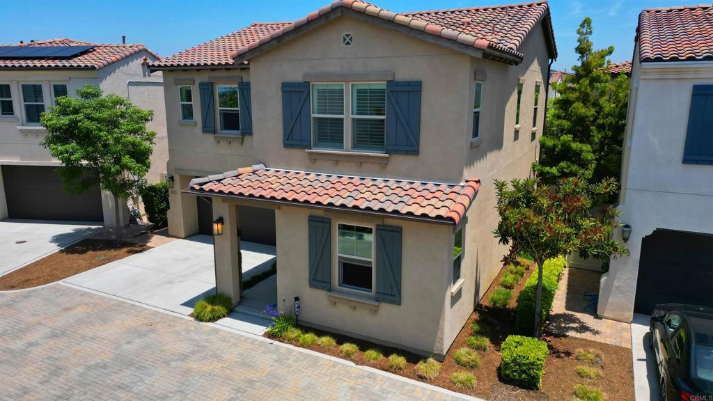 Absolutely Stunning Home in the Gated Rancho Tesoro Community! Located within the award-winning San Marcos School District, this gated community offers resort-style amenities including a pool, parks, picnic areas, BBQ's and direct access to Discovery Lake, South Park Lake, and miles of scenic hiking trails. Step into this bright and welcoming 4-bedroom, 3-bathroom home, featuring an open-concept layout filled with natural light and smart upgrades throughout. Located on a quiet cul-de-sac in the highly desirable Rancho Tesoro community, this home offers a perfect balance of comfort, style, and functionality. The heart of the home is a spacious kitchen boasting quartz countertops, a custom tile backsplash, stainless steel appliances, and an expansive island—ideal for cooking and entertaining. Adjacent living and dining spaces flow seamlessly, enhanced by Lutron smart lighting for effortless ambiance control. Enjoy the convenience of a first-floor bedroom and full bath, ideal for guests or multigenerational living. Upstairs, a generous loft provides flexible space for a home office, playroom, or media center. The primary suite is a true retreat with a spa-inspired bathroom featuring dual vanities, a soaking tub, a separate custom glass shower, and a walk-in closet. Outside, the low-maintenance backyard is your private oasis, complete with a living wall and tranquil sitting area—perfect for relaxing or entertaining. The west-facing orientation provides beautiful foothill views and glowing sunsets.
