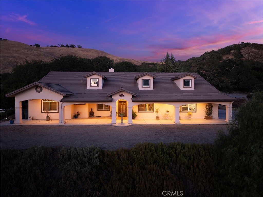 Introducing “Elk View Ranch” — a thoughtfully designed custom home in coveted Riverview Estates within Heritage Ranch, just minutes from Lake Nacimiento and Paso Robles Wine Country. Built with 2”x6” framing for superior insulation and long-term durability, this single-level residence blends craftsmanship with comfort. A fully owned 28-panel solar system powers the entire property — with no energy or true-up bills — ensuring exceptional efficiency and minimal utility costs. Inside, vaulted ceilings and expansive windows flood the living space with natural light and panoramic views. The living area centers around a striking wood-burning fireplace with a hand-laid stone surround and a reclaimed 1830s barn wood mantel — a one-of-a-kind focal point. The open layout connects the living room, dining area, and kitchen, creating a natural flow throughout. The kitchen features stone accents, granite countertops, rich wood cabinetry, and a large walk-in pantry. Off the main living area, a dedicated office or library offers quiet space for reading, remote work, or creative pursuits. Down the hallway, you'll find the primary suite, two additional bedrooms, and a full bathroom. The primary suite includes backyard access, an oversized jacuzzi, walk-in shower, dual vanity, and a large walk-in closet — your private retreat. The secondary bedrooms offer large windows, ceiling fans, and ample closet space. The shared bathroom includes a dual vanity, tub/shower combo, and abundant storage. Outside, enjoy beautifully maintained grounds and an attached 4-car garage with room for recreational vehicles, boats, or a workshop. Additional features include a whole-home water softener, recirculating hot water pump, and automatic sprinklers front and back. The property also offers a mini orchard with two cherry trees, two plum trees, a nectarine, a fig, and a fruit-bearing Meyer lemon tree — yielding homegrown harvests year-round. Located in the secure, gated community of Heritage Ranch, residents enjoy access to a boat launch, lake dock, swimming pool, pickleball courts, clubhouse, scenic trails, and more. Whether you're searching for a peaceful full-time residence or a high-quality weekend escape, “Elk View Ranch” offers rare attention to detail, lasting comfort, and easy access to nature, wine country, and recreation.