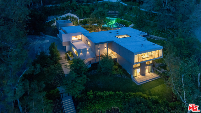 Spectacular contemporary estate on large 56,491 sq ft lot perfectly situated in prime Bel Air minutes from the Bel Air Hotel on a private (gated cul-de-sac of 2 homes by June, 2018). This residence was designed w/glass sliding doors & sky ceiling windows to enjoy sunny skies, lush green mountains & gardens from every room. Delightful living rm w/upper library gallery to enjoy mountain views. Dining rm/kitchen open w/Fleetwood doors for wonderful flow to outdoor living rm & dining area w/firepl. Spacious chef's eat-in kitchen w/intimate family rm. Master suite w/separate sitting area & elegant marble master bath & walk-in closet. 2 masters & 2 suites up. Movie theater/family rm w/double sliding glass doors opening to spacious green lawns & trees w/separate wine bar lounge. Resort style pool w/flowing decks for large scale entertaining & private guest house w/kitchenette & bath. Smart home automation. A compelling home proudly designed & offered by ANR Signature Collection.