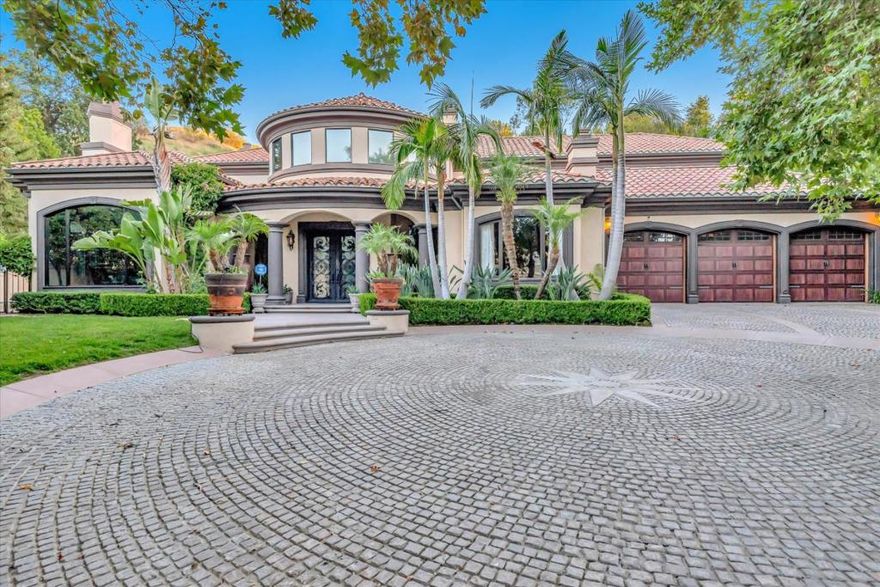 Presenting an exquisite masterpiece nestled within the prestigious, guard-gated enclave of Mountain View Estates in Calabasas, a sanctuary for the discerning connoisseur of luxury living. This magnificent home, poised at the cul-de-sac's end, offers an impressive 7,300 sq ft of luxurious living space, encompassing 7 bedrooms and 6.5 bathrooms, resting on an expansive 1-acre estate.  This grand abode has undergone a nearly million-dollar transformation. Imported, contemporary tiles, as well as wide plank, oil-finished wood floors. Upon entering the grand foyer, a sense of refinement envelops you as your gaze is drawn to the wood stairs with custom grey iron rail. Throughout the home, imported Cantera stone fireplaces enhance the formal dining room, primary bathroom, and formal living room. Your primary suite features a spacious sitting area, a luxurious sauna, an oversized spa, and sumptuous leather-feel stone counters, as well as an expansive balcony.  Embrace the splendor of outdoor living in the resort-style yard, with a covered patio clad in travertine tiles and equipped with heaters, a fire pit, and numerous seating and entertainment enclaves. Completing this outdoor oasis is a sparkling pool and spa, enhanced by captivating fountains and water features.