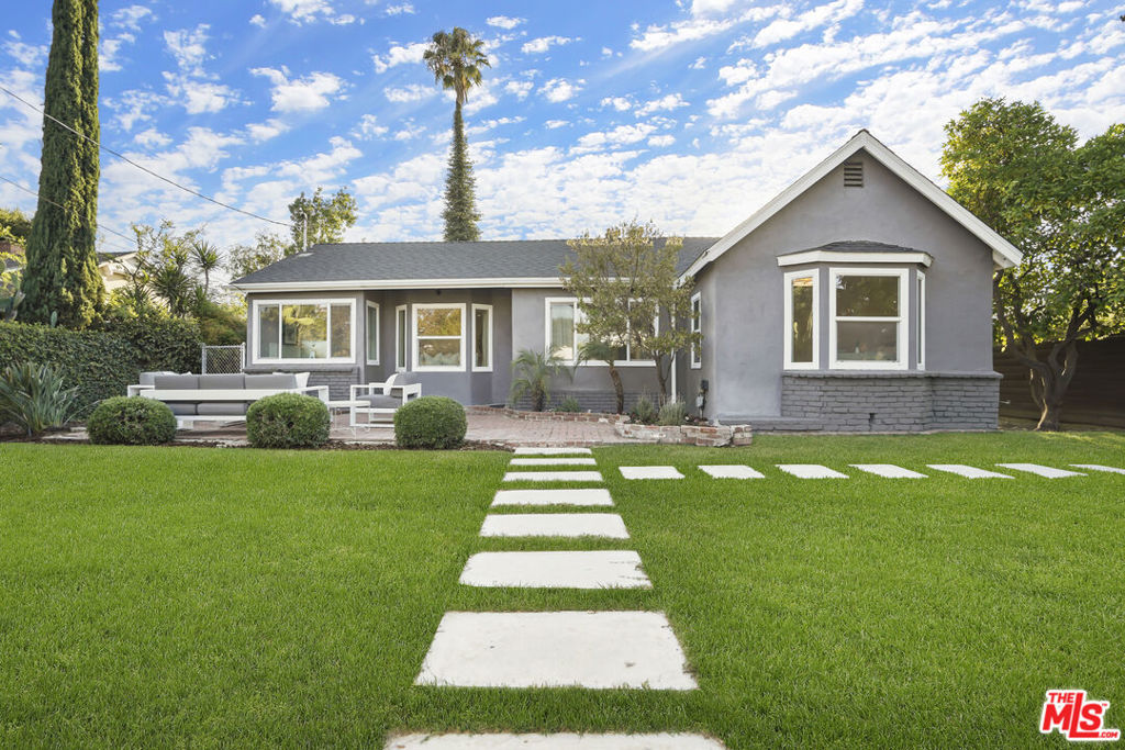 Style, form and function come together beautifully in this exceptionally updated 1930s California Traditional sited in the most sought after neighborhoods in Valley Village: An idyllic, vibrant tree lined community and wonderful place to call home! With a lush fusion of floral and greenery and fully hedged and gated for privacy and security, the home resides on a sweeping 8,000+ sq.ft. corner double lot across from the award winning Colfax Charter Elementary School (Ranked 9th best charter school in California!). Updated with the design and amenities ideally suited for today's contemporary lifestyle, the home features an appealing open floor plan that provides gracious transition from room to room, suffused in an abundance of natural light from expansive use of windows. Wide plank wood floors grace the living areas. Recessed lighting glows throughout the home. Modernized baths feature fine lighting, fixtures and finishes. The open concept kitchen is optimally designed for the adventurous at home chef and features high end stainless steel appliances, Carrera marble counters and breakfast bar, butler's pantry and adjoining sunlit breakfast room. Becoming one with the great room, it's the perfect gathering place for entertaining with friends and family. French doors bring the outdoors in and give way to a sprawling backyard lawn, deck, patio and pergola perfect for al fresco leisure. Three bedrooms plus a den, with three baths including a lux primary suite round out the comfortable accommodations for family and guests. Centrally located just moments from beloved Valley Village Park, NBC, CBS, Disney, Warner Bros. and Universal Studios, and the art galleries, studios, eateries, and theaters of the famed NoHo Arts District. Welcome!