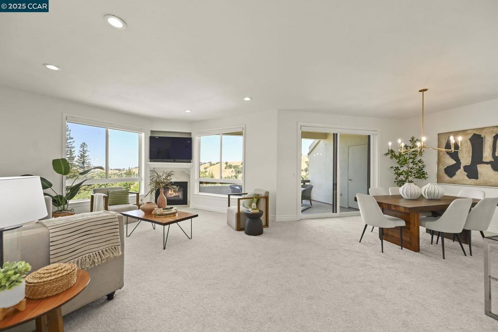 Spectacular Villa Nuevo condo with panoramic Mt. Diablo and hillside views from every window! This spacious 3-bedroom, 2-bath, 1661sf home in Rossmoor has been beautifully updated, featuring a remodeled kitchen with quartz countertops and Bosch & GE Profile appliances. Family room and formal dining area features a cozy fireplace and patio with views. Fresh paint, new carpet, luxury vinyl flooring, and modern lighting add to the move-in appeal. The serene primary suite boasts a private patio with stunning Mt. Diablo views, perfect for morning coffee. Primary remodeled bathroom includes dual vanity, luxury vinyl flooring and sitting area. Additional highlights include dedicated laundry with washer/dryer, elevator or one flight of stairs access, one-car detached garage, and covered carport. Enjoy the elevated Rossmoor active lifestyle in this remarkable home!