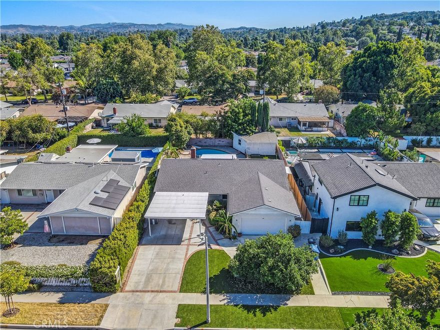 Welcome to the heart of West Hills! This tranquil and safe neighborhood is adorned with tree-lined streets and offers beautiful views of nature, the neighborhood, and city lights. This spacious home features an open floor plan with over 2,000 sqft, including a large living room and family room with new engineered hardwood floors and a wet bar. The custom kitchen boasts quartz countertops, custom cabinets, and brand-new stainless-steel appliances, including a range oven, dishwasher, and refrigerator. Newly installed highly efficient solar panels, Energy-saving LED recessed ceiling lights, tankless water heater, and newer energy-efficient windows and sliding doors. The family room features a cozy gas/wood-burning fireplace and leads to four spacious bedrooms and three beautifully remodeled bathrooms, providing ample space for luxurious living. The open layout connects the living room, family room, and kitchen, creating an inviting atmosphere for relaxation and entertainment, complemented by an inside laundry room. The garage has been converted into an ADU, serving as a potential fourth bedroom with its own attached bath, or as a studio or guest unit with a separate entrance perfect for extended family or rental income. The expansive backyard offers a serene retreat amidst nature, and a private covered patio is ideal for barbecuing, entertaining, or children's play. There is a recreation room, in the backyard, which is ideal for a your private GYM, game room,  study room, additional guest room, for meditation, children’s play room, changing room after swimming, and or just for relaxing etc. With plenty of street parking for guests, this home is conveniently located near grocery stores, shopping centers, fine dining, public transportation, Topanga Village (less than 10 minutes away), the 101 & 118 Freeways, and award-winning schools. Discover the perfect blend of comfort and convenience!