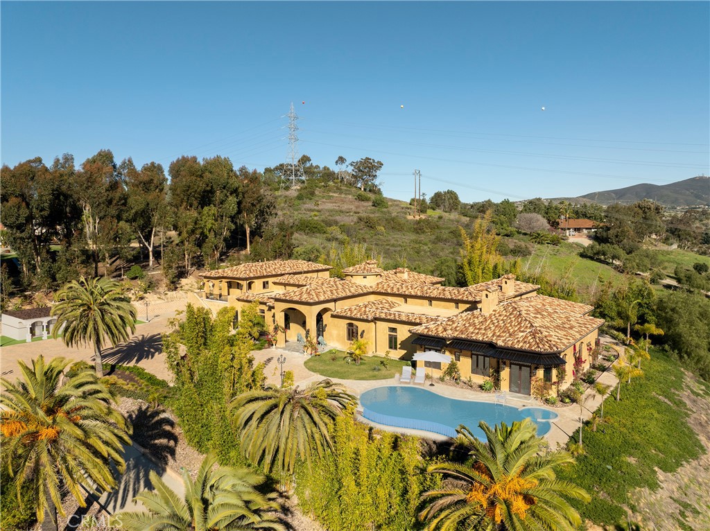 Please note that the above-referenced price reflects the Reserve Price for the property, which is available for purchase through a luxury bidding opportunity. Submit offers now. Seller reserves the right to accept or reject offers and additional terms apply. Please visit Paramount Realty USA’s website for more details. SINGLE-STORY & GUEST UNIT, NEW CONSTRUCTION completed in 2023. Meticulously designed combining luxury by a renowned Feng Shui master to ensure harmony & ample natural light, every detail has been tailored to create an elegant living space on this RARE ELEVATED 2.23 acres with coastal breezes. Entering the PRIVATE double Gates, youre captivated in serenity & privacy, setting the stage for a remarkable living experience. The hand-forged iron double doors entrance welcomes you into a space adorned with Italian Carrara white marble floors & handcrafted wood panels. Platinum iron arched rails & natural Ashlar marble columns enhance the flow of energy throughout the home. The living spaces are bathed in natural light through the stained glass skylights & arched windows, infusing each room with positive chi. Czech crystal chandeliers & intricate wood carvings add a touch of opulence, while custom cherry wood cabinets provide both functionality & beauty. The formal living room with a marble fireplace, surrounded by marble walls that radiate warmth & luxury. The primary suite boasts a marble fireplace, wool carpet, sauna, two bathrooms & two walk-in closets. Entertaining in the family room & bar/wine cellar, Italian marble floors, creates an atmosphere of sophistication & conviviality. The gourmet kitchen with Italian marble floors, cherry wood cabinets, & state-of-the-art Miele appliances, is a chef's dream. The second-story guest unit is attached to the single-story main residence offers its own private entrance with two bedrooms, two bathrooms, kitchen, living room, laundry room & two decks. Outdoor amenities include a BBQ kitchen area perfect for al fresco dining. Highly rated schools, golf, race track & nearby coast, this property stands as a testament to the art of living well in modern luxury. Property offers the opportunity to build an Accessory Dwelling Unit. Pool, garages/unit, primary bedroom, hallway, living room & office images are conceptual intended to illustrate potential ideas & are not to scale. Relevant entities approval are required. Pool blueprints available to preview. Sold furnished with exempted items.