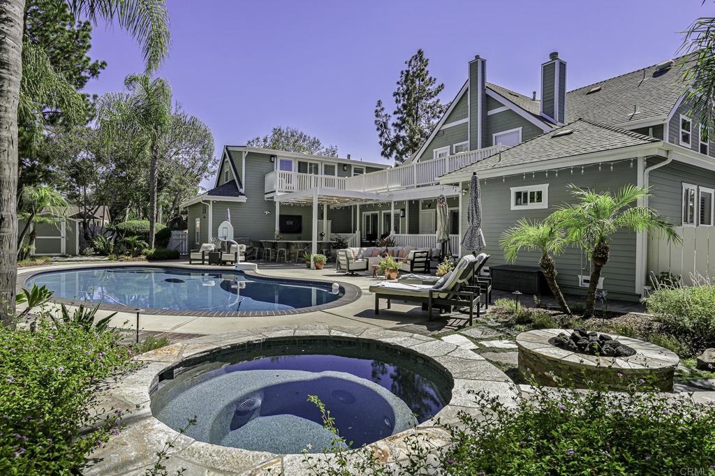 Welcome to your dream oasis at 14403 Gaslight Ct, Poway, CA! This stunning single-family home, nestled on a desirable corner lot in a cul-de-sac, offers an expansive 4,113 square feet of luxurious living space. With five spacious bedrooms + a private office, many of the bedrooms are ensuite. Located in Old Poway, with walkability to restaurants, shops, schools and the park! As you step inside, you'll be greeted by dual pane windows that flood the home with natural light, accentuating the western exposure. The grand foyer leads you to a formal dining room, ideal for hosting dinner parties, and a versatile home office that fits your work-from-home needs. The chef’s kitchen is a culinary enthusiast’s delight, featuring a butler's pantry, Sub Zero refrigerator, Viking gas stove and range, an island kitchen, a dishwasher, and a wine cooler. Gorgeous marble tile in the kitchen with an extra 2 drawer freezer. The perfect entertainer's kitchen! Outdoor living is at its finest with a covered deck, a heated below-ground pool, and a hot tub, all set within a private yard. Entertain guests with a built-in barbecue, outdoor grill, and kitchen, or unwind by the fire pit under the stars. The meticulously landscaped front and back yards are complemented by a private patio and wrap around balcony. An ADU with attached bathroom and balcony overlooking the pool area has its own private entrance and has been completely upgraded. Additional features include central AC and heating, primary suite is on the main floor, a dedicated laundry room, and a dry sauna in the primary bathroom. This home is a sanctuary of elegance and privacy, offering a unique lifestyle that blends luxury with comfort. Don't miss this rare opportunity to own a piece of paradise in Poway!