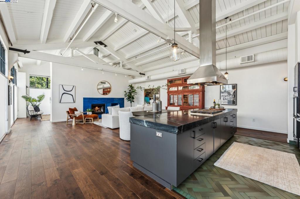 Live, work and create in this oversized 3 bedroom, 2 bathroom, Jack London Square condo that blends industrial edge with modern comfort, uniquely designed for those who thrive in bright, adaptable spaces. Soaring ceilings and expansive street-level windows flood the open living area with natural light while also offering unique visibility for those seeking a live/work lifestyle. At the heart of the home, a chef’s kitchen with Viking appliances and a striking center island create a seamless hub for meals and mingling. Two bonus rooms provide flexible options for an office, studio, gym or client-facing workspace. With generous storage, private rear bedrooms and a floorplan designed for both productivity and relaxation, this home adapts to your needs with ease. Secure parking and a gated street entrance add peace of mind, while shared outdoor spaces extend your living beyond the front door. Step outside to enjoy the waterfront, indie cafés, farmers market and neighborhood energy that defines JLS living. With ferry service to SF, BART and freeways nearby, commuting is seamless - yet entirely optional. This rare opportunity offers professionals, creatives and urban upsizers both scale and style in a vibrant space that balances play with productivity.
