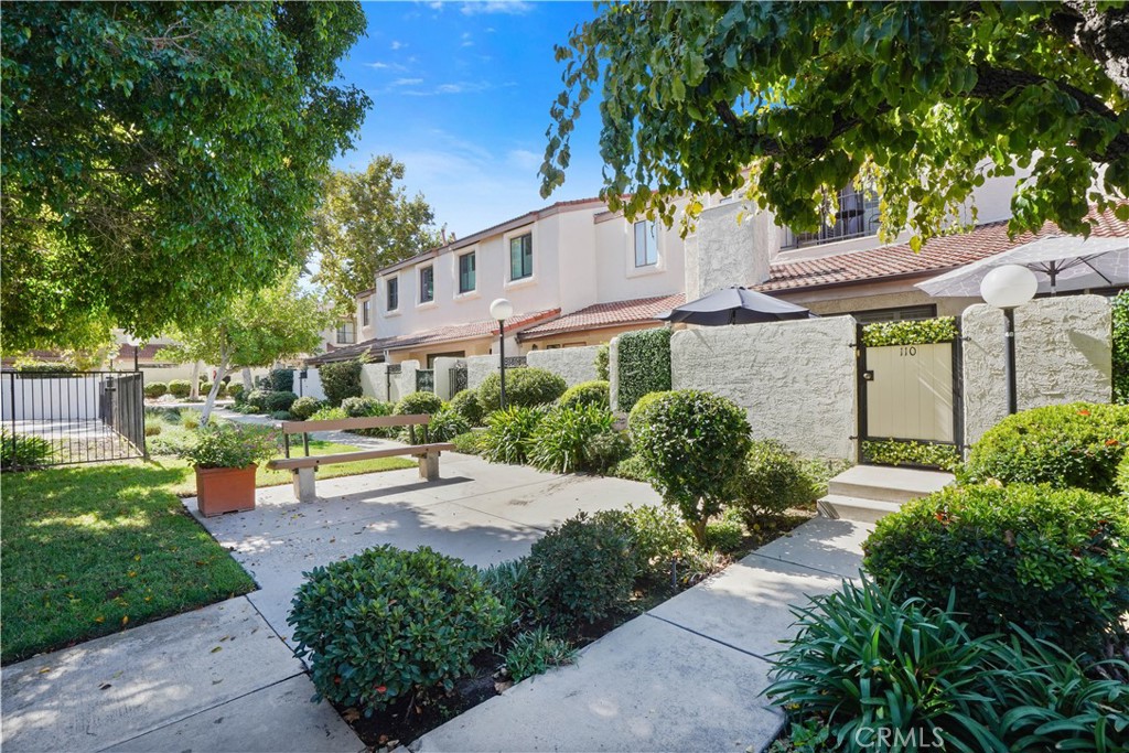 Welcome to your new home in the heart of Tarzana. Tucked into a serene, amenity-rich community, this beautifully maintained 3-bedroom, 3-bath tri-level townhome blends a thoughtful layout with meaningful upgrades-creating a space that feels as warm as it is functional.
The main level welcomes you with soaring ceilings, natural light, and a flowing floor plan that balances openness and comfort. The living room features a cozy fireplace and floor-to-ceiling shutters that open to your private front patio- a peaceful outdoor retreat, perfect for morning coffee, sunset dinners, or simply unwinding.
Just beyond, a welcoming dining area creates a cozy corner for meals or entertaining. The kitchen is both stylish and practical, featuring granite countertops, stainless steel appliances, an electric stove, rich cabinetry, and a sunny breakfast area to start your day.
Also on this level is a flexible bedroom and full bathroom-ideal for guests, in-laws, a playroom, or home office, offering adaptability to suit your lifestyle.
Upstairs, the spacious primary suite feels like a private escape, complete with its own balcony, built-in cabinetry, a vanity nook, and generous closet space. The en-suite bath features modern finishes, a luxurious soaking tub, and separate shower. A third bedroom and full bath round out the upper level with comfort and privacy.
Downstairs, the garage level offers in-unit laundry, extra storage, and direct access to your oversized 2-car garage-bringing ease and functionality to daily life. Recent upgrades include a new roof (2024), brand-new washer and dryer, and electric stove-all ready for the next lucky owner.
As part of a well-maintained community, you'll enjoy beautifully landscaped grounds and resort-style amenities including two sparkling pools, a spa/jacuzzi, a racquetball court, fitness room, and clubhouse. HOA dues also conveniently cover trash, water, earthquake insurance, roof maintenance, and common area upkeep-making life here as low-maintenance as it is elevated.
Located just minutes from Ventura Blvd’s top dining and shopping, you're near local favorites like Blu Jam Café, Wanderlust Creamery, Gasolina Café, Katsu-Ya, and Baltaire, along with Trader Joe’s, Whole Foods, Gelson’s, Equinox, LA Fitness, and easy access to the 101 Freeway.
Comfortable, refined, and full of heart- this Tarzana townhome is the lifestyle upgrade you’ve been waiting for.