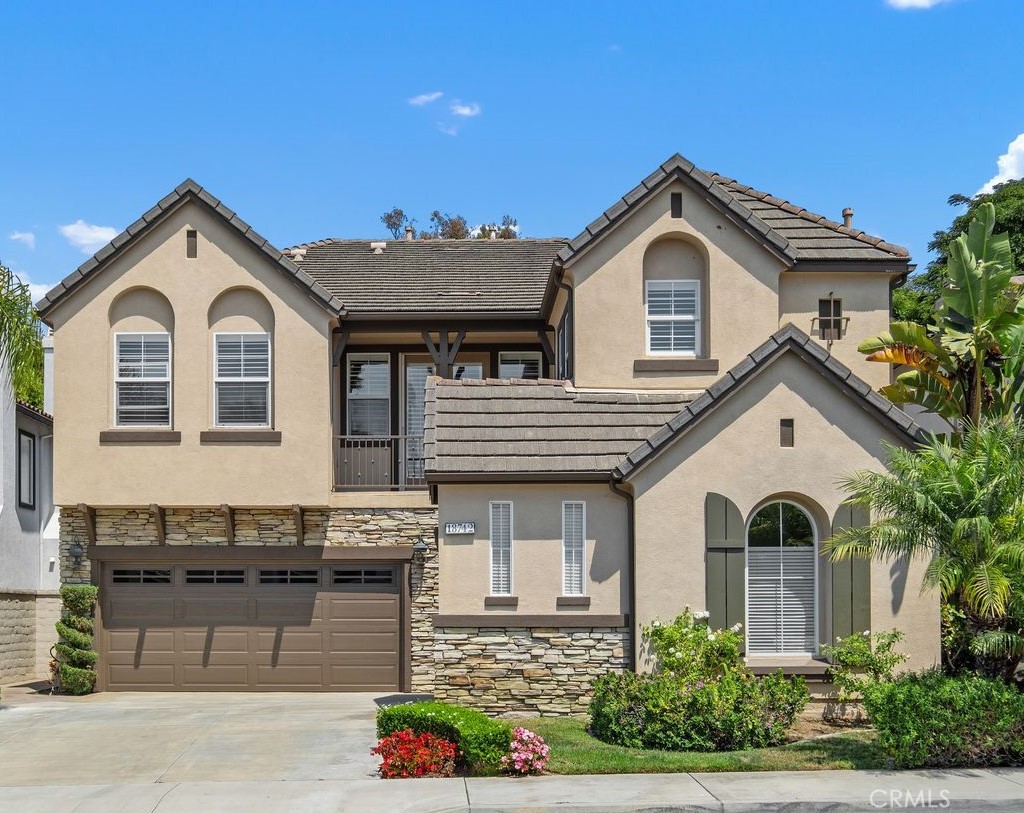 As stately as it is serene, this stunning 4 bed | 5 bath residence, located within the gates of the exclusive Crystalaire community in Huntington Beach, demands your full attention. Newly remodeled with luxurious and modern updates, this breathtaking home offers comfort and tranquility backing to a greenbelt with mature trees and quiet cul-de-sac location. The floor plan is elegant and expansive: designed to impress and inspire at every turn. On entry, you'll step into a stunning great room with soaring ceilings, an elaborate staircase, dining and gathering areas, and outdoor access to a relaxing yard with water feature and beautiful palm trees. The welcoming gourmet kitchen is newly updated and features quartz countertops, stunning tile backsplash, modern lighting, Wolf gas range, double ovens, brand new built-in refrigerator, dishwasher, wine refrigerator, and microwave. A massive center island and bright breakfast area open to adjacent family room which is anchored with a gas fireplace making this a great area to entertain family and friends. In addition, the main level includes a richly appointed dining room, powder room, and main level bedroom with en-suite bath. Upstairs, a large show-stopping primary suite awaits with a private deck and a spa-inspired bath with dual vanities, granite countertops, a large tub and separate shower, and a huge walk-in closet. Completing the upper level is a library/office area with built-in cabinetry, convenient laundry room, two additional bedrooms, one with an en-suite bath, a full hall bathroom, and built-in desk in upper hallway with granite countertop. Every element of this home has been thoughtfully curated for the discerning buyer. Outdoors, the private sanctuary impresses beyond belief with beautiful trees, flowers, and multiple seating areas across the upper and lower patio/deck. Additional highlights include a 2-car garage with epoxy floor and a separate single car garage. Well-located within the enclave of Crystalaire, take a short stroll to the community pool and hot tub, minutes from beautiful downtown Huntington Beach and pier, award-winning schools, parks, shopping centers, dining, and the stunning beaches of Surf City USA. Move-in ready, with exceptional upgrades and finishes, this home has it all! Simply put, if you're looking for a true luxury retreat in one of Huntington Beach’s most exclusive communities, you've found it!