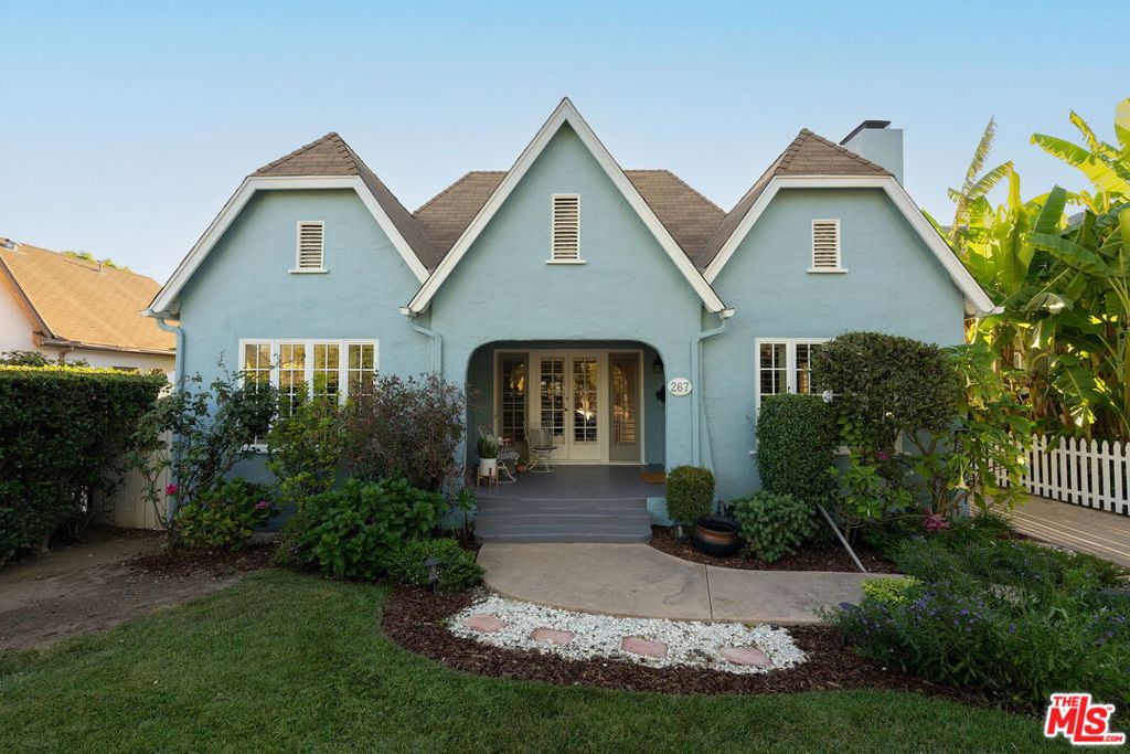 Nestled in Pasadena's highly coveted CalTech neighborhood, this enchanting English cottage feels like it's been lifted straight from the pages of a storybook. Beyond the charming white picket fence and lush front garden, a welcoming patio and classic red door set the stage for the warmth within. Inside, sunlight pours into the inviting living room, accented by a cozy fireplace and timeless shutters throughout. The bright, airy kitchen features a central island and French doors that open to a dreamy backyard, an ideal setting for al fresco dining. The formal dining room also boasts French doors with shutters, offering a seamless connection to the front patio. The home offers three spacious bedrooms, each adorned with white shutters. The largest bedroom enjoys its own set of French doors leading to a deck overlooking the picturesque backyard. In addition to the main home's three bedrooms and one bath, a detached studio ADU with a loft provides a versatile space perfect for guests, a home office, or creative retreat. The backyard is a true sanctuary, perfect for intimate dinners or lively gatherings beneath the soft glow of tea lights strung through the trees. All of this, just moments from Rosebud Coffee, Jameson Brown Coffee Roasters, Pasadena Plaza, The Huntington Gardens, and so much more. This rare offering is not to be missed.