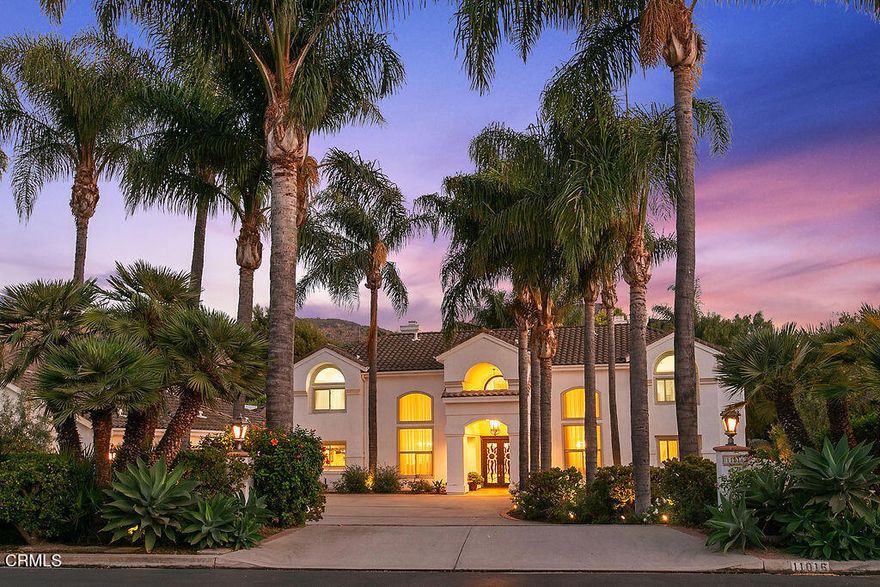 Extraordinary modern Mediterranean in gated Camelot Estates! Situated on a prime acre corner lot in prestigious Santa Rosa Valley, this completely reimagined two-story villa showcases timeless architectural elegance with contemporary luxury. Over 5,400 sq ft 'under roof,' this residence welcomes with a grand foyer, soaring volume ceilings, columns, and archways, all bathed in natural light. The redesigned island kitchen features top-tier appliances, custom cabinetry, and opens seamlessly to the family room. An entertainer's dream, the home boasts a gourmet indoor kitchen with commercial venting, rotisserie, smoker with solar-powered vent, and stainless barbecue. Offering 5 spacious bedrooms and 5 baths--including oversized ensuite secondary bedrooms--plus a dedicated office/library. Resort-inspired grounds include a dazzling palm-encircled pool with covered pavilion, peaceful waterfall koi pond, fruit orchard, lush landscaping, and sports court, all with complete privacy. A rare opportunity to own a turnkey Camelot Estates masterpiece designed for luxury living and grand entertaining.