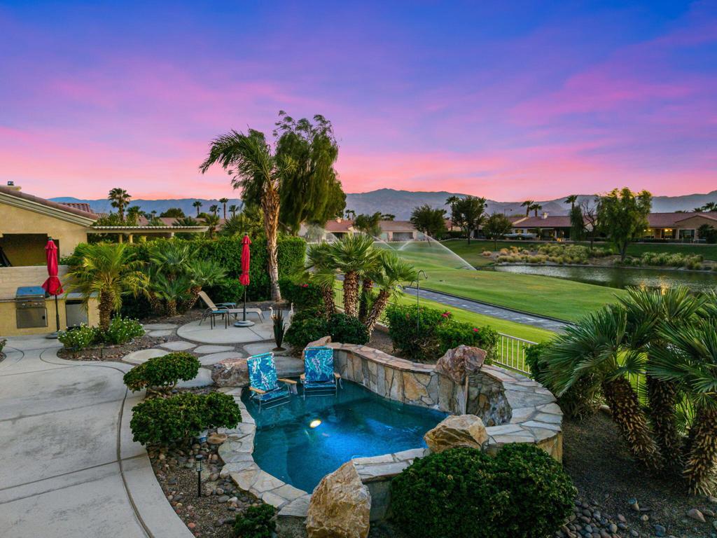 Incredible Views | Resort-Style Backyard | Designer Upgrades Throughout |Experience sweeping GOLF COURSE, LAKE, and MOUNTAIN VIEWS from this west-facing beauty in Sun City Shadow Hills, a vibrant, guard-gated, 55+ active adult community with top-tier amenities, including golf, tennis, a state-of-the art fitness center, pools/spas and an array of clubs and activities! Low HOA fees also include Internet access, security and use of the Clubhouse.Set on the 5th fairway, the resort-style backyard is a true showstopper--featuring a custom rock WATERFALL and SPOOL with color changing lights, gas FIREPIT, built-in BBQ w/mini fridge, herb gardens, and a new wrought-iron fence to enhance the panoramic vistas. Spectacular sunsets and peaceful birdwatching complete this exceptional outdoor retreat. Inside, the home impresses with a REMODELED CHEF'S KITCHEN (quartz counters, Bosch double ovens, solid-wood cabinets), a spacious great room with remodeled gas fireplace, and custom lighting and window treatments throughout. The primary suite boasts a EXTENSIVE SPA-LIKE BATH RENOVATION with quartz countertop and custom backspash, walk-in shower, motion lighting, and clever storage. Additional highlights: new carpet (w/lifetime warranty), new tankless water heater, Honeywell smart thermostat, EPOXY FLOOR GARAGE with mini-split air conditioner, and more. This home offers elevated style and an unbeatable outdoor lifestyle! Schedule your private showing today!