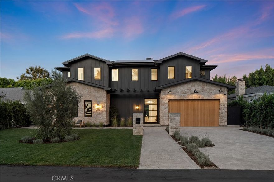 A bold statement in modern luxury living, this brand-new construction estate with an ADU sits on a sprawling lot in the heart of Valley Village. Designed for both everyday living and effortless entertaining, the open-concept main living area is anchored by a state-of-the-art chef’s kitchen equipped with premium Thermador smart appliances and a massive island with seating. The space is completed by a formal dining room and spacious living room that boasts an oversized sliding glass door which opens for seamless indoor-outdoor living. Step outside to the expansive backyard retreat where you can enjoy taking a dip in the sparkling pool/spa, or relax and unwind on the low maintenance artificial turf yard. Upstairs, you’ll find four generously sized ensuite bedrooms and a dedicated laundry room. The refined primary suite features a spacious private balcony, custom walk-in closet and spa-inspired bathroom, complete with a soaking tub, rainfall shower and double vanity. The attached ADU, with its own private entrance, offers a living room with a kitchenette, two bedrooms and two bathrooms. This versatile space is perfect for extended family, guests, an office or gym – the possibilities are endless. Additional highlights include a multifunctional media room, high ceilings throughout, a two-car garage and Control4 smart home system with built-in speakers, security cameras, a Nest thermostat and more. This property is ideally located within the top rated Colfax School District and only moments away from exceptional shopping, dining and entertainment options found nearby at NoHo Art District and along Ventura Boulevard.