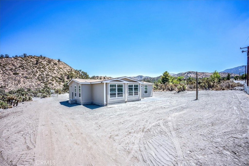 Discover 7593 Buckwheat Rd, a rare find in the peaceful setting of Wrightwood. Situated in Wild Horse Canyon just below town, this fully fenced parcel is prepared for a new manufactured home and offers a blend of privacy and convenience. Tucked between the mountains and the desert, the property provides a quiet retreat while remaining just minutes from Hwy 2 and Hwy 138, making commuting and shopping easily accessible. Zoned for horses and located within the Snowline School District, the land is ideal for equestrian use or simply enjoying extra room to spread out. The Wrightwood community is celebrated for its mountain-town character and year-round recreation, including skiing at nearby Mountain High Resort, hiking the Pacific Crest Trail, and exploring local shops, dining, and scenic drives. Whether you’re planning a full-time residence or a weekend escape, this property is a wonderful opportunity to enjoy the best of mountain living with modern convenience.