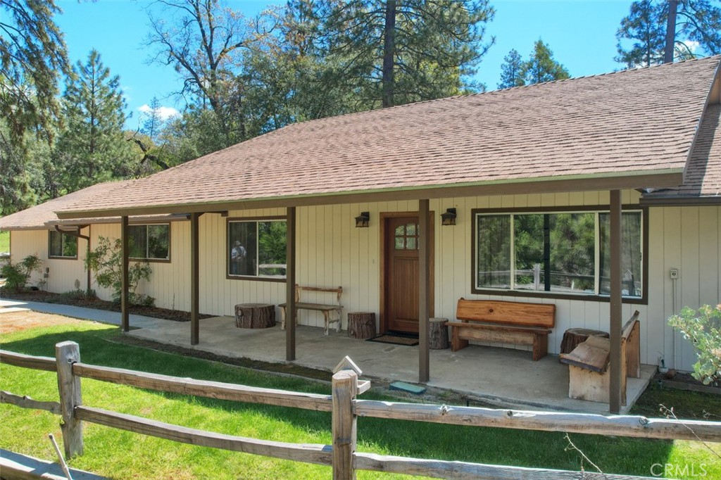 Successful vacation rental in Sky Ranch with a private well! This charming turnkey 3 bedroom, 2 bath home has a garage conversion into a game room that could be a 4th bedroom! Large living room with fireplace, vaulted ceilings and skylights. The kitchen has a great breakfast bar set up for sharing with the living room. Tile counters, electric range with stainless steel range hood, dishwasher and extra cabinet storage. The laundry room is huge with storage space and access to the back yard. Guest bedrooms have ceiling fans and the guest bath has a large walk-in shower. Primary bedroom has a walk-in closet, ceiling fan and also has a large walk-in shower. The back patio offers an above ground spa to relax. This home with a concrete driveway has an ideal location for fun and adventure being just 15 minutes to Yosemite National Park entrance for wonderful sightseeing, nature exploring and snow skiing and 10 minutes to Bass Lake for fishing, boating and water skiing. Add this wonderful home to your tour list today!