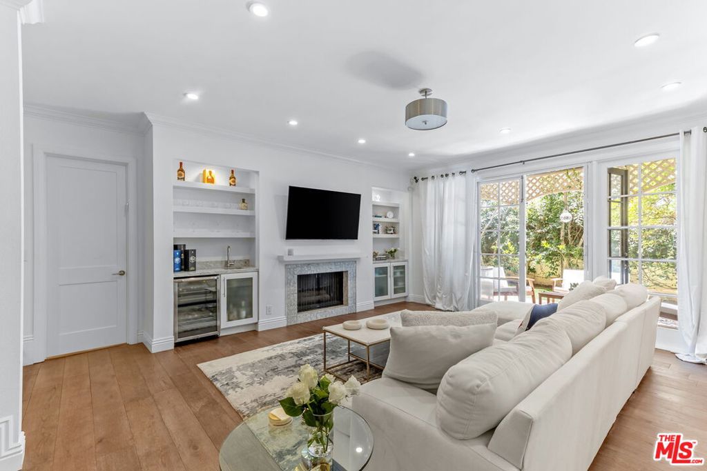 Welcome to this bright and beautifully appointed 2-bedroom, 2-bathroom condo offering 1,755 sq ft of refined living space in the heart of Beverly Hills. Thoughtfully designed, this sophisticated home features tasteful wood flooring throughout, high ceilings, and an open layout that seamlessly blends style and comfort. The gourmet kitchen is fully equipped with stainless steel appliances, custom cabinetry, and ample counter space perfect for both everyday living and hosting. Just beyond the living area, step outside to your exclusive-use outdoor space, complete with lush grass an ideal setting for entertaining, relaxing, or enjoying the quintessential California indoor-outdoor lifestyle. The expansive primary suite is a true retreat, featuring a spacious walk-in closet and a luxurious spa-like bathroom with a double vanity, oversized soaking tub, and a sleek free-standing shower. A generous second bedroom and well-appointed second bathroom complete the home. Located just blocks from world-renowned Rodeo Drive, and minutes from Beverly Hills' finest dining, shopping, and nightlife, this home offers the ultimate blend of comfort, elegance, and convenience. This home is also situated in the highly acclaimed Beverly Hills Unified School District, making it an ideal choice for families and professionals alike. Don't miss your chance to live in one of L.A.'s most coveted neighborhoods! (The price advertised is offered at market rate with an initial term of 13 months or more).