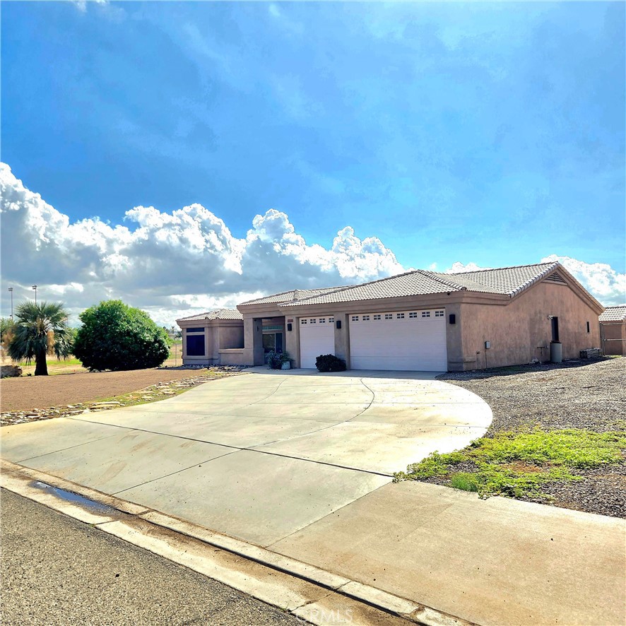 Welcome to 11333 Desert Trailways Ln in Blythe — a Riverside County–permitted property situated on a 1-acre cul-de-sac lot. This home offers exceptional privacy with no neighbors on one side or behind the property, along with backyard views of a beautiful green field.
The interior features an inviting open floor plan with abundant natural light. Modern smart-home conveniences include a security monitoring system, programmable thermostat, and upgraded electronic door hardware designed for convenience and peace of mind. Utilities include private well water, septic system, and propane service, plus a 12x12 detached storage unit for additional space.
Approved for rental use, including short-term and mid-term stays, this property offers flexibility as a primary residence, retreat, or investment. Outdoor areas provide ample room for relaxation, entertaining, or enjoying the desert landscape. Conveniently located near the Colorado River and freeway access to California and Arizona destinations, this home combines comfort, privacy, and opportunity in a desirable Blythe setting.