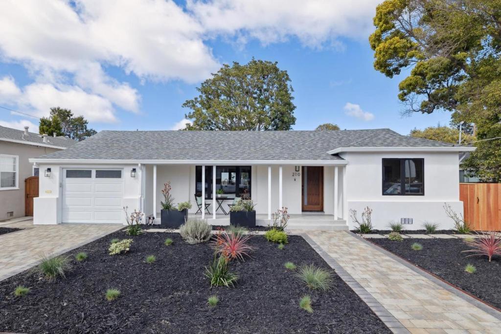 Welcome to 210 31st Avenue, San Mateo, CA a magnificent blend of elegance and modern design. This meticulously renovated residence boasts 4 luxurious en-suite bedrooms along with a half bath, ensuring comfort and privacy. The home features an open layout that effortlessly flows, creating a seamless connection between the main living areas. The centerpiece of this stunning home is the gourmet chef's kitchen, equipped with top-of-the-line Thermador appliances and custom-designed cabinetry. A true highlight is the oversized 10ft x 5ft waterfall island, offering both a functional workspace and a striking design element. The expansive living room, with its generous proportions, is ideal for relaxation and entertaining. Large patio doors extend the living area outdoors, where a beautiful deck awaits. This outdoor oasis is perfect for hosting gatherings or simply enjoying a tranquil moment. Additionally, the home is equipped with a mini split AC/Heating system for year-round comfort. Situated near the Hillsdale Parks and Shopping Center, this home offers unparalleled convenience. Every corner of this residence has been thoughtfully crafted to offer a harmonious blend of style and function. Discover the unmatched beauty and sophistication of this exceptional San Mateo home today.