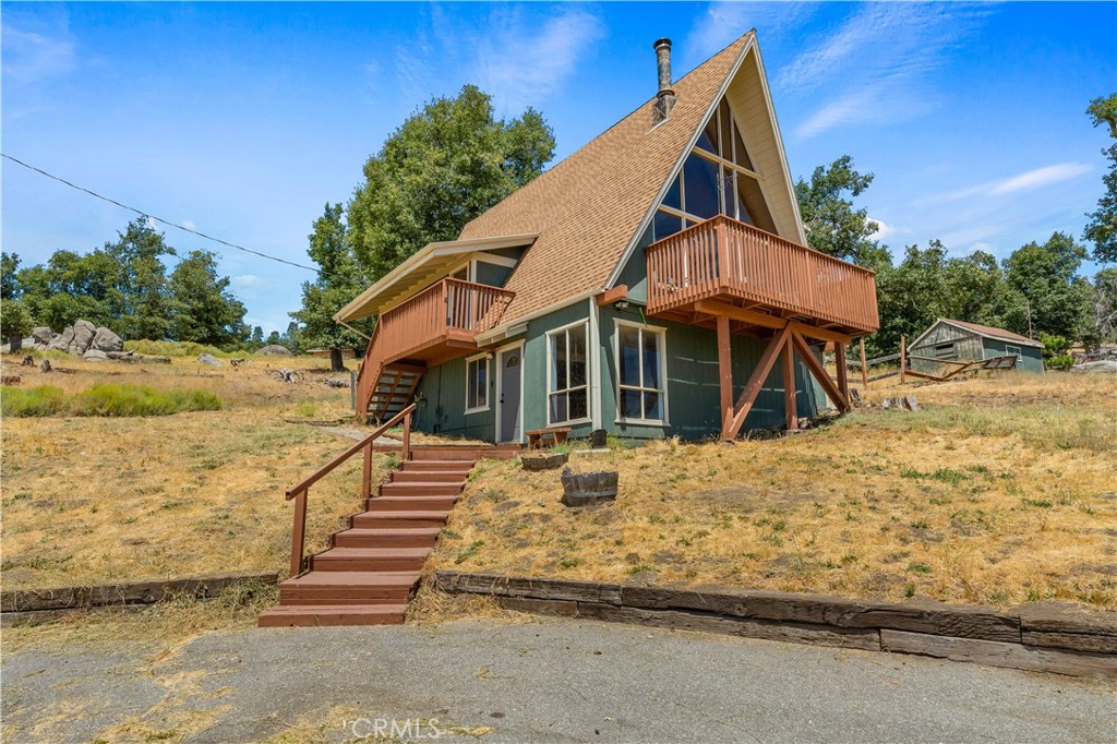 Stunning mountain views and the charm of a modern cabin! This Bear Valley Springs beauty is perched above the valley on over an acre and has been remodeled from top to bottom. With over 1,700 sq ft of living space spread across three levels, you'll find two bedrooms and a loft on the top floor, a main-level primary suite, kitchen, dining, and living area, and a lower-level bonus room with laundry and a separate entrance.
Step out from the main living room onto a spacious deckthe perfect spot to relax and take in the panoramic views. The cabin-style charm has been fully updated, offering a perfect blend of rustic and refined. Detached two-car garage and solar system included (buyer to assume). Gated community amenities and peaceful mountain living complete the package.