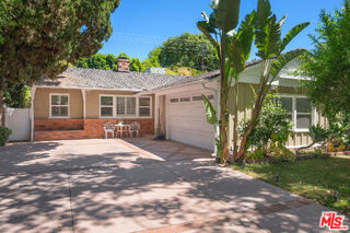 Discover California living in this charming residence, perfectly situated in one of Woodland Hills' most sought-after neighborhoods. Just moments from Ventura Boulevard, The Village at Topanga, and scenic canyon drives to the beach, this home offers the ultimate blend of convenience and serenity. Behind its inviting exterior awaits a sun-filled interior with gleaming hardwood floors, custom California shutters, and a beautifully remodeled chef's kitchen appointed with Viking appliances and granite countertops. The living room is anchored by a warm gas fireplace, while the serene primary suite opens directly to your own private backyard escape. Step outside to a lush oasis designed for year-round enjoyment complete with a sparkling pool, outdoor surround sound, and multiple spaces to dine, lounge, and entertain under the stars. Additional highlights include a fully integrated sound system inside and out, EV charging in the garage, and thoughtful upgrades throughout. Set within the highly acclaimed Woodland Hills Elementary Charter for Enriched Studies district, this is one of the best values south of the Boulevard. A rare opportunity to enjoy a home that embodies elegance, comfort, and the quintessential California lifestyle