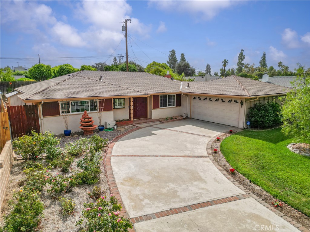 In 1962, when the world looked up in wonder as the first American orbited the Earth, this ranch-style home was built on a quiet cul-de-sac where neighbors still show pride of ownership. Time has only added to its charm. ~~~
Curb appeal comes to mind when you see this home and its curved driveway (plenty of parking) lined with flowers and lush landscaping one side of the Cul De Sac. Step through the formal entry, where the view opens toward the dining and living areas. The living room is spacious, with a half wall defining the dining area, yet the flow feels open and connected. Water-resistant laminate flooring runs throughout, lending both beauty and practicality. From the dining room, a window frames the landscaped front yard that includes roses and newly planted flowers along the curved driveway, while a ceiling fan adds comfort. ~~~
Just beyond, the kitchen shines with recessed lighting, a peninsula perfect for casual dining for two, and glass-front cabinets to display treasured dishware. The garden window above the sink brings in natural light and overlooks the wide side yard. A door leads directly to the garage, where laundry is conveniently tucked inside and space above with possibility of storage use. ~~~
Back in the living room, a fireplace creates a cozy focal point, while sliders open to the covered patio: a year-round retreat, rain or shine. Here, a fire pit invites conversation under the stars. An exterior garage door provides access to the side yard, where space and charm abound. The backyard offers thoughtfully landscaped touches, just enough lawn for play or the simple joy of grounding your toes in the grass. ~~~
Down the hallway, three generous bedrooms and two bathrooms await. The roomy primary suite features a large shower, built-in drawers and cabinets, and a garden window overlooking the front yard. Each bedroom is finished with mirrored closet doors, ceiling fans, and the same sleek, water-resistant flooring for a consistent look.~~~
A home born in a historic moment, yet timeless in its comfort: a place where everyday living is as inspiring as the era it was built in.
See it! Love it! Buy it!
Added note: Roof approximately 2 1/2 years old.
(See Virtual Link)