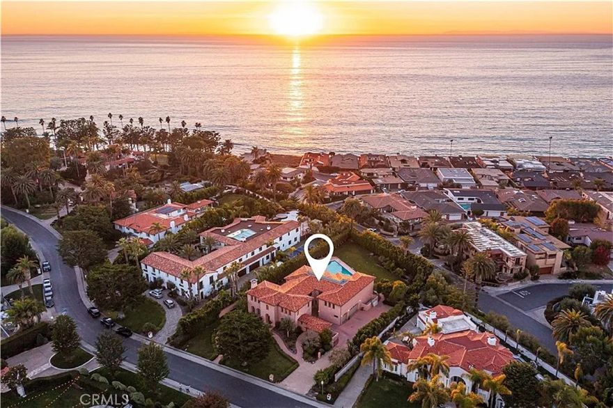 Welcome to Cotton Point, an exclusive enclave at the southernmost tip of San Clemente. This high security double-gated community is home to innovators and leaders, and is still where the “Western White House, Casa Pacifica" exists. Enjoy a convenient beach pathway to breathtaking ocean vistas overlooking renowned surf breaks and exclusive direct beach access through neighboring Cypress Shores. This is more than a neighborhood; it’s a private sanctuary redefining excellence. The estate at 4060 Calle Isabella pays homage to Spanish Revival architecture with hand-hewn beams, custom wrought iron, and artisan finishes that evoke warmth and elegance with appeal that will be appreciated by design enthusiasts and history lovers alike. The Spanish Mediterranean feel is enhanced by stucco walls, soft color tones, rustic elements, and a red clay tile roof creating a richly layered design complemented by arched doorways, a fountain, covered loggia and charming courtyards within the surrounding lush landscape. Inside, a multi-generational floor plan features a main level with formal living and dining rooms, fireplace, two generous bedrooms, two full size bathrooms, casual room, powder room and a very spacious kitchen. The second level provides bonus living space, laundry room, an office, two bedrooms sharing a “Hollywood” bathroom, and a primary suite with ocean-facing deck to enjoy fragrant ocean breezes, peek ocean views and a vantage point to overlook the large swimming size eighteen by forty five foot pool and yard area. Additional features include a mudroom, fire suppression system, Dutch doors, a dumbwaiter, radiant floor heating, and a garage plumbed for additional laundry area. The estate boasts carefully selected materials, including mahogany pillars,  and exquisite chandeliers. Special finishes include blue Bahia and blue Macayuba quartzite, Rosa del monte marble, Loewen windows and Baldwin hardware. Flooring selections incorporate Honduran mahogany and Spanish Roja Alicante tumbled marble. Meticulously landscaped front and rear yards feature specimen trees that grace the property with appealing textures and vibrant colors creating a sense of well being. Highly regarded public schools as well as private schools are nearby along with numerous restaurants and shops at charming old town Del Mar street. Three car garage and deep driveway area for guest parking. This estate is an opportunity to claim your place among the elite at the pinnacle of coastal living.