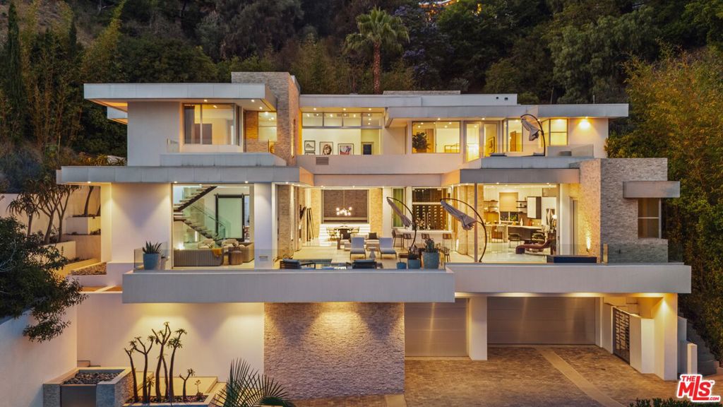Ultra private, gated, and secure, this modern architectural compound is nestled on a serene hillside in the highly coveted Beverly Hills Post Office, offering sweeping canyon and city views from nearly every vantage point. Designed with an emphasis on refined living and effortless entertaining, the light-filled residence boasts exceptional indoor-outdoor flow and a thoughtfully functional layout ideal for daily living. With six bedrooms and seven bathrooms across nearly 7,200 square feet, the home offers generous space for families and guests, along with multiple areas for work, relaxation, and entertainment. Carefully curated details elevate the living experience, such as an elevator, fully automatedCrestron system, temperature-controlled wine refrigerator, a floating glass and wood staircase, a gourmet kitchen with custom cabinetry and high-end appliances, multiple skylights, and many patios and balconies that capture the stunning views. The primary suite is a true retreat, featuring a fireplace, walk-in closet, spa-like ensuite bath, and a private terrace with breathtaking panoramic views of the city. Outside, enjoy a large patio with pool and spa, an outdoor grill, a seamless indoor-outdoor bar area, and expansive Fleetwood sliding glass doors that create a harmonious flow between interior living and natural surroundings. A grand, gated driveway sets the stage for a dramatic arrival, emphasizing the estate's privacy and presence. No expense was spared in the design and construction of this meticulously crafted residence, ideally located in the prestigious Crest Streets, just minutes from world-class dining, luxury shopping, and vibrant nightlife.
