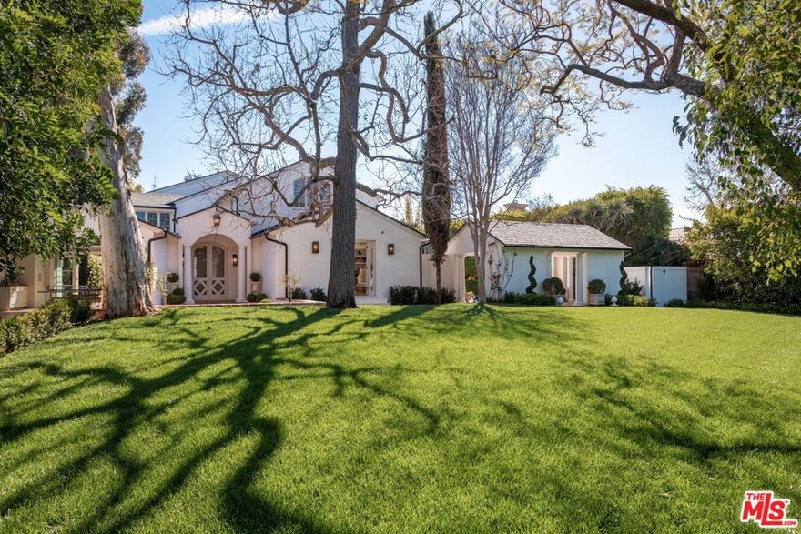 Spectacular style + unparalleled privacy come together in this one-of-a-kind 4 bed, 5 bath masterpiece in prime Hancock Park. Sited on an expansive, 17,100+ sqft lot, carefully considered details abound in this designer-owned compound. Set behind high hedges + a gated, tree-lined driveway, each indoor space flows effortlessly to the outdoors. The entry leads to a spectacular, sun-drenched arched walkway, open to a formal living rm w herringbone oak floors + de Gournay wallpaper. A parlor room w a custom bar is only steps from the front yard + limestone pool patio. The airy chefs kitchen w new appliances is situated between a breakfast area + a casual living rm, all of which open to outdoor dining + lounging, anchored by a fireplace + sparkling pool. With a peaked cathedral ceiling, brick floors + French doors open to outdoor spaces, the dining rm creates a refined entertaining hub. A downstairs office + exquisite powder rm complete the 1st floor. Upstairs, the primary suite features vaulted ceilings, custom cabinetry, his + hers baths + direct access to the pool via a dramatic, curved staircase. 3 more generously sized bedrooms w high ceilings + bright light complete the upstairs plan. The spacious + outfitted garage serves as a bonus space. Steeped in tradition + re-imagined for todays living, no detail was left untouched in this remarkable retreat.
