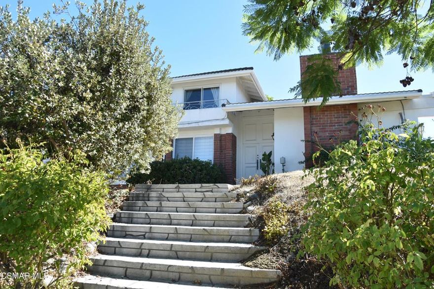 Location, location, location! Discover this spacious 5-bedroom, 3-bathroom Woodland Hills home, offering over 2,600 sq. ft. of comfortable living space.  The main level is convenient for entertaining, featuring a formal living room, a versatile family room complete with a wet bar, and an eat-in kitchen alongside a separate, dedicated dining room. This floor is finished with two well-appointed bedrooms and a full hallway bathroom, perfect for guests or a home office.Upstairs, the expansive and private quarters await. The primary suite is oversized and accompanied by two additional spacious secondary bedrooms. Each of the upstairs rooms enjoys private balcony access that frames picturesque, sweeping views--an ideal spot for morning coffee or evening relaxation.  The generous rear yard  boasts a classic brick fire pit, mature citrus and pomegranate trees, a dedicated children's play area, and a swimming pool--your escape for those warm Southern California summers.