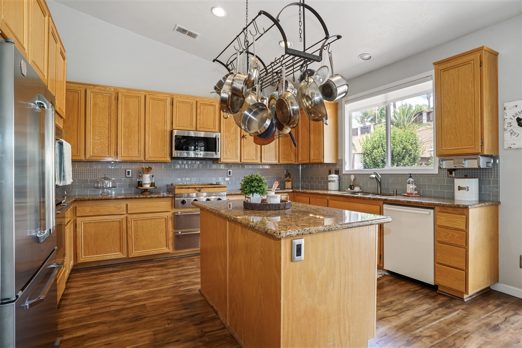 Don't miss out on viewing this beautiful half-acre corner lot home with an abundance of upgrades throughout! There is plenty of room for RV/Toy parking, and is an entertainers dream! Interior has Dacor stainless steel kitchen appliances, high-grade engineered wood flooring, granite counter-tops, QuietCool whole house fan, and upgraded HVAC are just a portion of the amenities this house offers. Exterior has owned paid off solar panels, irrigation well and fenced raised garden beds with fruit bearing trees.. Neighborhoods: Ramona Equipment: Dryer, Range/Oven, Washer Other Fees: 0 Sewer: Sewer Connected Topography: LL