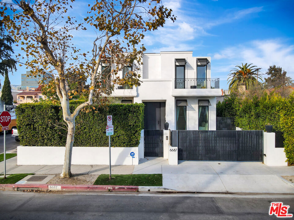 Modern Luxury in the Heart of LA, 5 Bedrooms | 5 Bathrooms + 1-Bedroom Guest House | Saltwater Pool + Spa | Designer Finishes | Smart Home Technology Welcome to this strikingly elegant, architecturally significant modern estate, a masterclass in design and sophistication. this residence is located just moments from shopping and dining .Meticulously crafted with the finest materials and innovative technology, this 5-bedroom, 5-bathroom residencecomplete with a fully detached 1-bedroom guest houseoffers a lifestyle of effortless elegance and comfort.Step inside and be enveloped by soaring 12-foot ceilings, custom real white oak slats and hidden-panel wood walls, soundproof Fleetwood windows, and a seamless blend of indoor-outdoor living. Floor-to-ceiling glass walls open the home to lush outdoor spaces, blurring the boundaries between inside and out.At the heart of the home lies a state-of-the-art chef's kitchen, featuring sleek Italian cabinetry, dual Miele dishwashers, and a striking porcelain island with integrated hidden phone chargersdesigned for both gourmet entertaining and everyday functionality.The open-concept living and dining spaces are adorned with designer furnishings by B&B Italia, curated dcor, and a Lutron lighting system that allows for ambiance at the touch of a button. A Bose surround sound system flows throughout every room, including the guest house, offering a premium audio experience inside and out.Retreat to the luxurious primary suite, complete with a private terrace, and a spa-like en-suite bathroom showcasing Italian natural limestone, a steam shower, soaking tub, his-and-hers vanities, and a separate water closet. A concealed, full-wall wardrobe features integrated lighting.Each of the additional bedrooms and bathrooms are thoughtfully designed with the same attention to detail featuring rich wood paneling, Graff fixtures, and imported stonework that elevate everyday living.The resort-style backyard is a sanctuary of tranquility and style, boasting a saltwater pool and spa, a fully integrated entertainment system, and multiple outdoor lounging and dining areas ideal for hosting or relaxing under the stars.The detached guest house is equally impressive, offering a private bedroom, full bath, and a chic kitchenette, perfect for guests or extended stays.