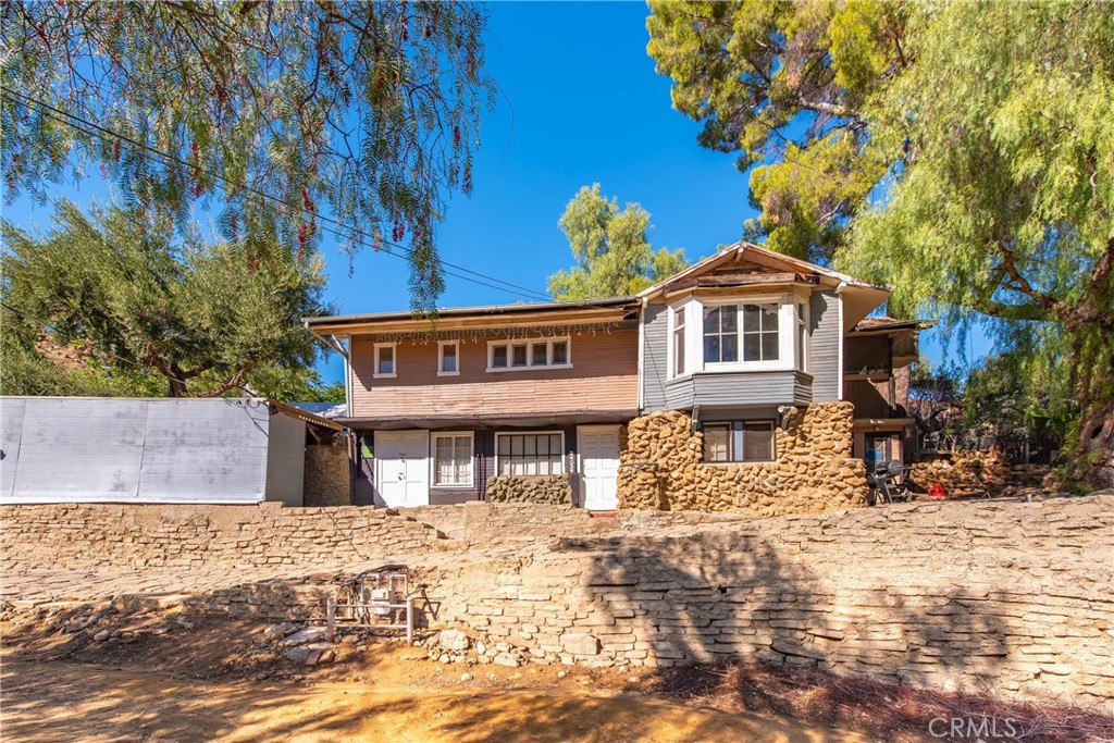Discover an incredible opportunity to restore or reinvent this 1br 1ba charming 1920s cabin, nestled in the highly sought-after West Hills neighborhood of Lakeside Park. Resting upon an almost 14,000 square foot lot. Boasting stunning views of the Grand Rocks, mountains, and rolling hills, this two-story fixer-upper features a basement and a spacious living room with large, picturesque windows that beautifully showcase the scenic surroundings. Includes enclosed side patio area. The eclectic neighborhood blends large new constructions with rustic, vintage cabins, offering a unique and inspiring setting. Bring your vision and contractor to transform this historic property into your dream home or a remarkable renovation project. Don't miss out on this exceptional chance to create something truly special!