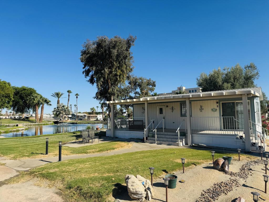 RARE OPPORTUNITY - TWO LOTS ON THE POND!This unique offering includes two adjoining lots sold together - giving you extra space, privacy, and unbeatable value.Lot #399 features a charming park model home with a lush green yard.Lot #398 serves as the front yard, complete with an in-ground sprinkler system, extended driveway, and storage shed.What truly sets this property apart is its setting - Lot #399 borders a park-owned grassy lot, meaning your home is surrounded by wide-open green space unlike anything else in the community.Enjoy peaceful pond views and a prime location just steps from the laundry facilities and main pool.The home is being sold turn-key, fully furnished and ready for you to move in and start enjoying right away.