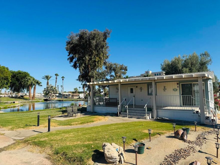 RARE OPPORTUNITY - TWO LOTS ON THE POND!This unique offering includes two adjoining lots sold together - giving you extra space, privacy, and unbeatable value.Lot #399 features a charming park model home with a lush green yard.Lot #398 serves as the front yard, complete with an in-ground sprinkler system, extended driveway, and storage shed.What truly sets this property apart is its setting - Lot #399 borders a park-owned grassy lot, meaning your home is surrounded by wide-open green space unlike anything else in the community.Enjoy peaceful pond views and a prime location just steps from the laundry facilities and main pool.The home is being sold turn-key, fully furnished and ready for you to move in and start enjoying right away.