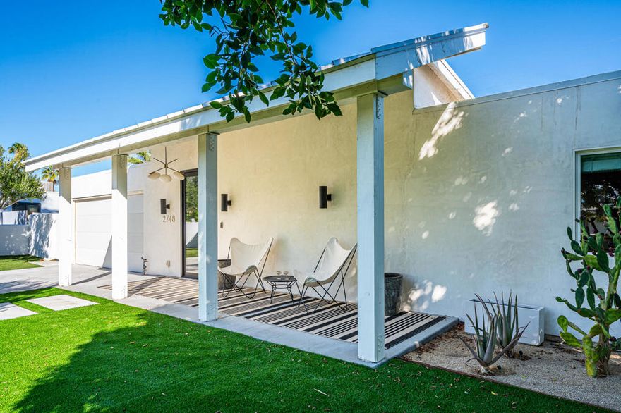 Modern designer home with mountain views! Fully renovated and reimagined contemporary home with panoramic mountain views in desirable Palm Springs. This modern residence features 3 bedrooms, 2.5 baths, and exceptional attention to detail throughout. The entry showcases a stunning full-glass door, leading to an expansive living room with vaulted wooden slat ceilings and skylights that fill the space with natural light. The gourmet kitchen includes black stainless-steel appliances, quartz countertops, open shelving, and a breakfast bar, flowing into a dining area and den--ideal for everyday living and entertaining. The primary ensuite offers a spa-like bath with a soaking tub, walk-in shower, and custom closet system. Guest bedroom also features extra-deep closets with built-ins, and the third bedroom could pull double duty as an office or guest space with a daybed, wardrobe, and desk. Enjoy resort-style outdoor living with mountain views, artificial turf, a saltwater lap pool, above-ground spa, and a covered cabana with outdoor lounge and dining areas. An attached two-car garage with mini-split AC provides flexible use for fitness or workspace. The property is fully fenced with an electronic sliding gate, shaded front yard, and mature plants and trees. Offered fully furnished. Available now for a 12-month lease.