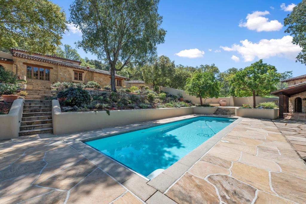 Stunning Hacienda Compound with Separate Guest House, Pool House, and Greenhouse Amidst Beautifully Landscaped Courtyards. Formal Entry Elegant Living Room. Separate Office with Built-ins. Formal Dining Room. Chef's Kitchen with Center Island, Wolf Appliances, and Breakfast Room Opens to Spacious Family Room with Fireplace and Built-ins. Primary Suite Retreat Features Double Sinks, Stall Shower, Stone Soaking Tub, and Two Walk-in Closets. 4 Spacious Bedrooms. 4.5 Bathrooms. Upper Level Features Spacious Loft and Full Bathroom. Lower Level Features Expansive Wine Cellar. Interior Features Include High Ceilings, Multi-Zone Heating and Airconditioning, Laundry Room, and Vaulted Ceilings. Separate Guest House Includes Kitchen, Fireplace, and Full Bathroom. Separate Pool House Includes Full Bathroom. Lovely Landscaped 2.86 +/- Acre Lot with Sparkling Pool, Enclosed Courtyards, Mature Cactus Gardens and Landscaping, and Hand Laid Stonework. Award Winning Portola Valley Schools.