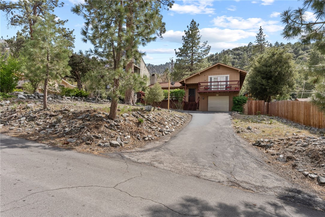 Move in condition! Pride of ownership inside and out! Nicely laid out home in desired area of Wrightwood with views of desert below. Home features large living room with a Cozy fireplace, vinyl window thought out the home. Nice sized bedrooms one with it own sliding glass door and balcony with beautiful views! Installed NEW ROOF. Home has plenty of storage including built-ins. Large full bath and 1/2 bath off kitchen. Gallery style kitchen open to dining area with quartz counter tops and stainless steel appliances. Refrigerator stays! Beautiful back and side yard designed to relax and enjoy the fresh air and trees. Two oversized decks. Single car garage. A must see ! Priced right and ready to move in.