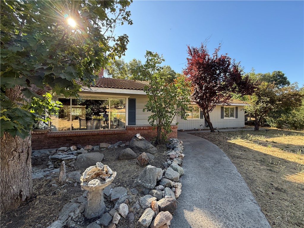 WONDERFUL 3 ACRE PARCEL AND HOME WITH TWO SEASONAL CREEKS LOCATED IN BOOTJACK. This sweet Three Bed, Two Bath home features over 2000SF of living space and offers a super comfortable layout with open concept design. Adorable Kitchen is complete with all the necessary (Newer) appliances as well as large Island that seats five and Dining area enhanced with Beadboard and Chair Rail molding transforming an ordinary space into extraordinary. FUN FLOORPLAN includes two woodstoves and a DOUBLE-SIDED FIREPLACE offering TWICE THE WARMTH AND TWICE THE CHARM. Central air and heat as well as two freestanding wood stoves will do the job during those cold nights. Large Master with access to outdoor sitting space will call your name each morning with cup of coffee. The sellers took great pride indoors and out as the manicured grounds will have you wishing you had come to live the simple life much sooner. The covered porch is a great conversation area and comes with a TV. Large Bonus room complete with professional size pool table will keep you entertained. Stone entry will welcome your guests and provide that Rustic Earth feel just adding to the comfort this home already exudes. Additionally, Fridge, Washer and Dryer also stays. The setting alone here is worth viewing with THE EYE-CATCHING BOULDERS AND ANCIENT OAK TREES leading to the Seasonal Creeks. You can even pick your own Blackberries for that homemade pie. Location from Mariposa town is approximately 10 minutes with the Bootjack Market and Gas just a hop, skip and jump down the road. No need to come into town for that gallon of milk. Centrally located between Mariposa and Oakhurst this sweet property offers convenience and comfort in so many ways.